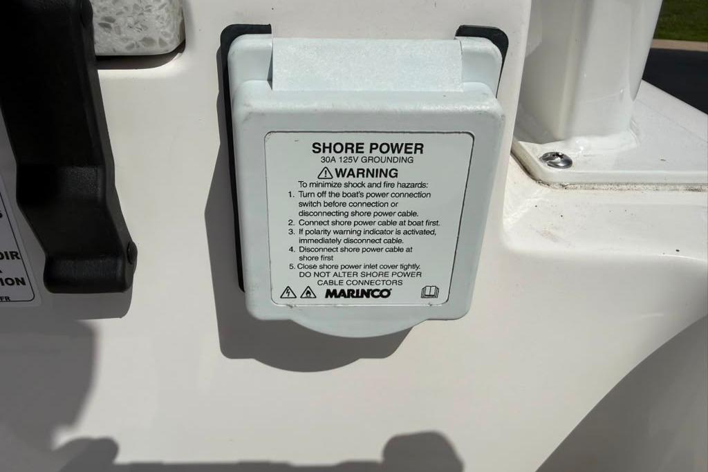 Shore power connection on 2026 Sea Fox 288 Traveler boat with safety instructions.