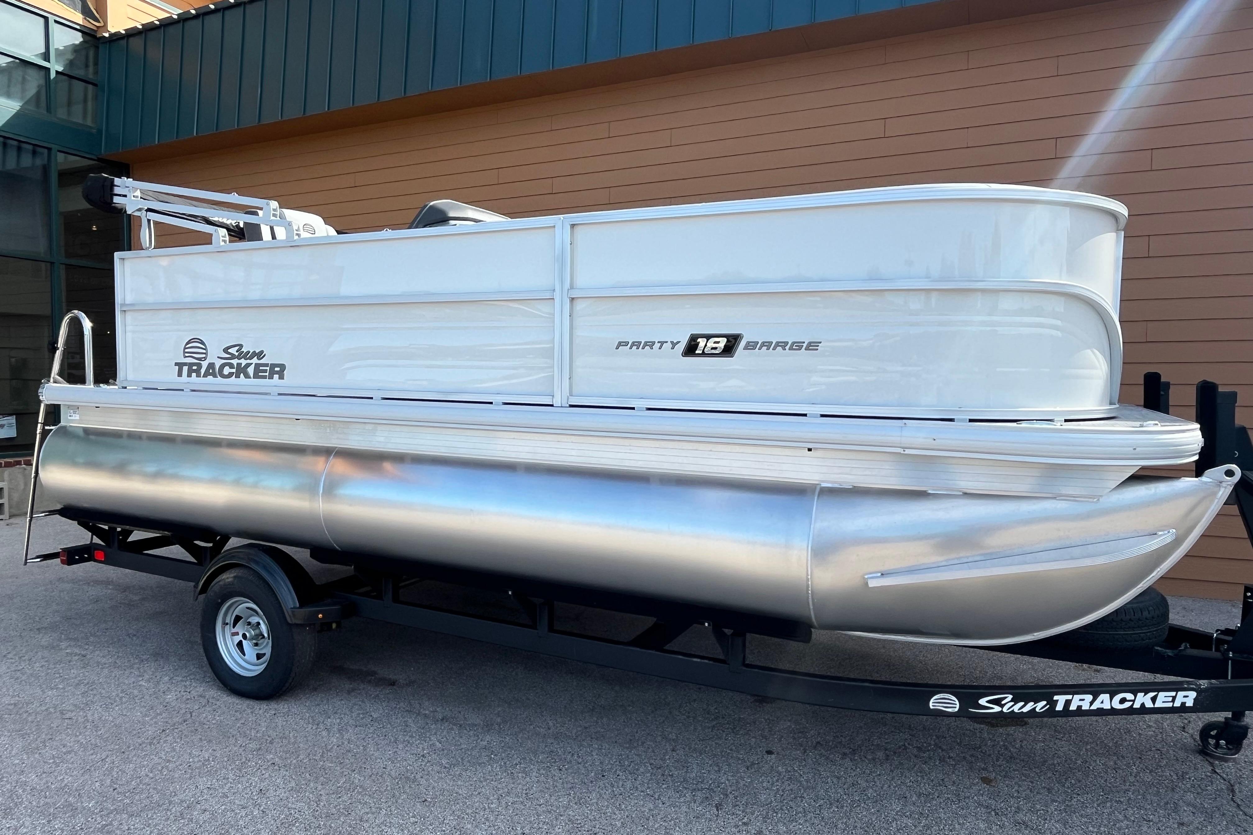 2026 Sun Tracker Party Barge 18 DLX pontoon boat on trailer, side view.
