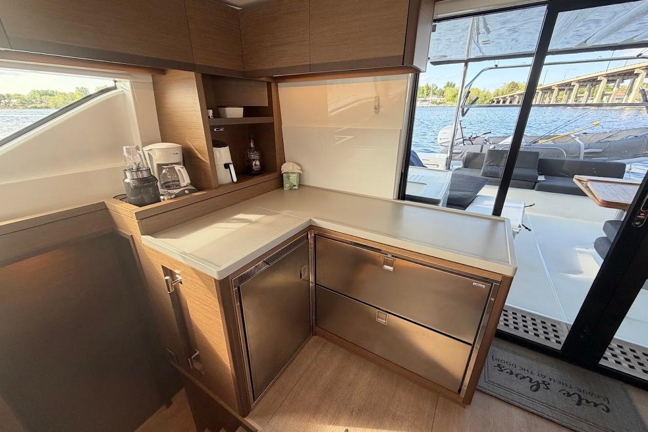 Modern kitchen area on a 2021 Lagoon 50 yacht with outdoor view.