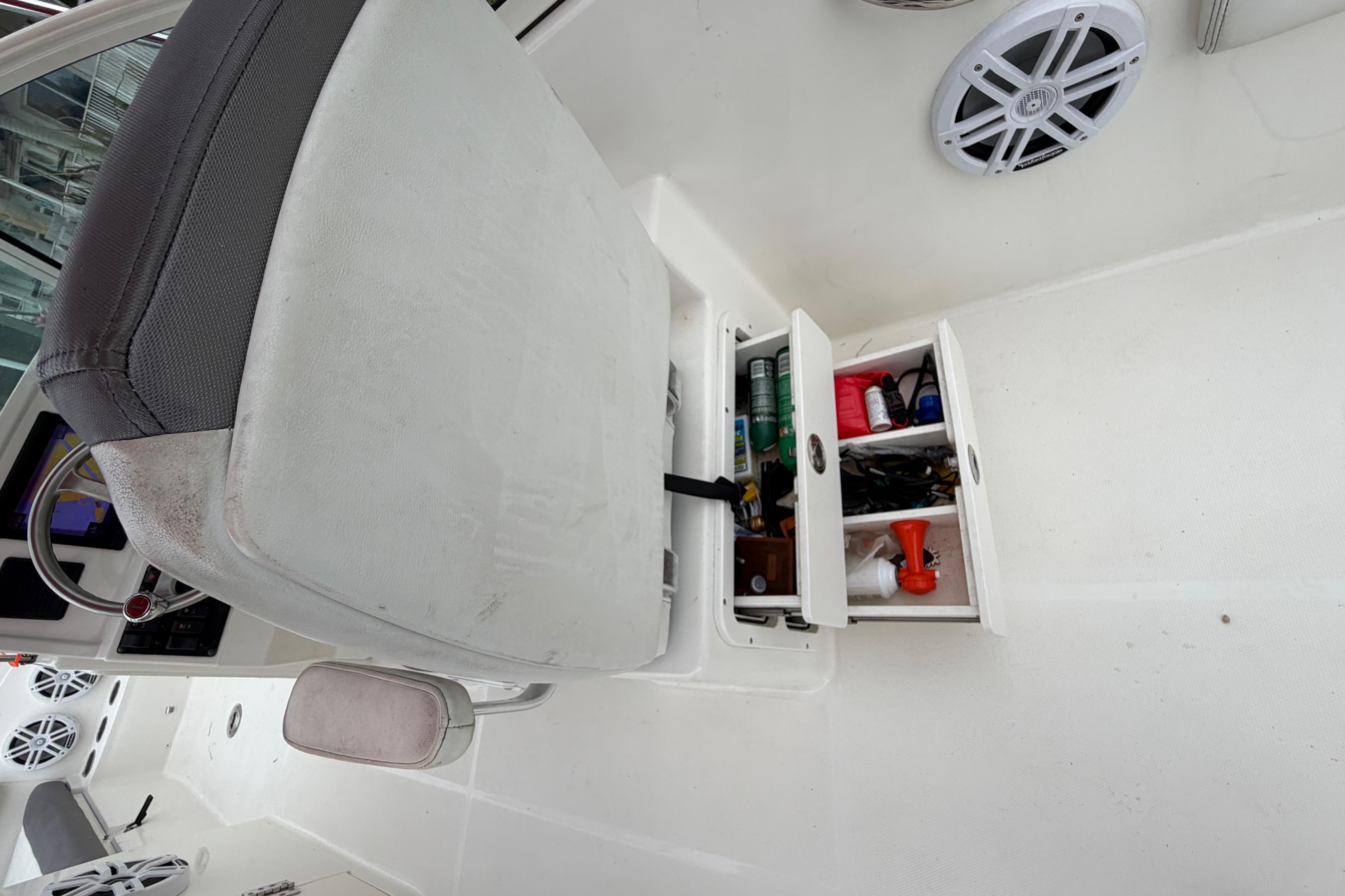 Storage compartment on 2019 World Cat 230 DC boat with various items inside.