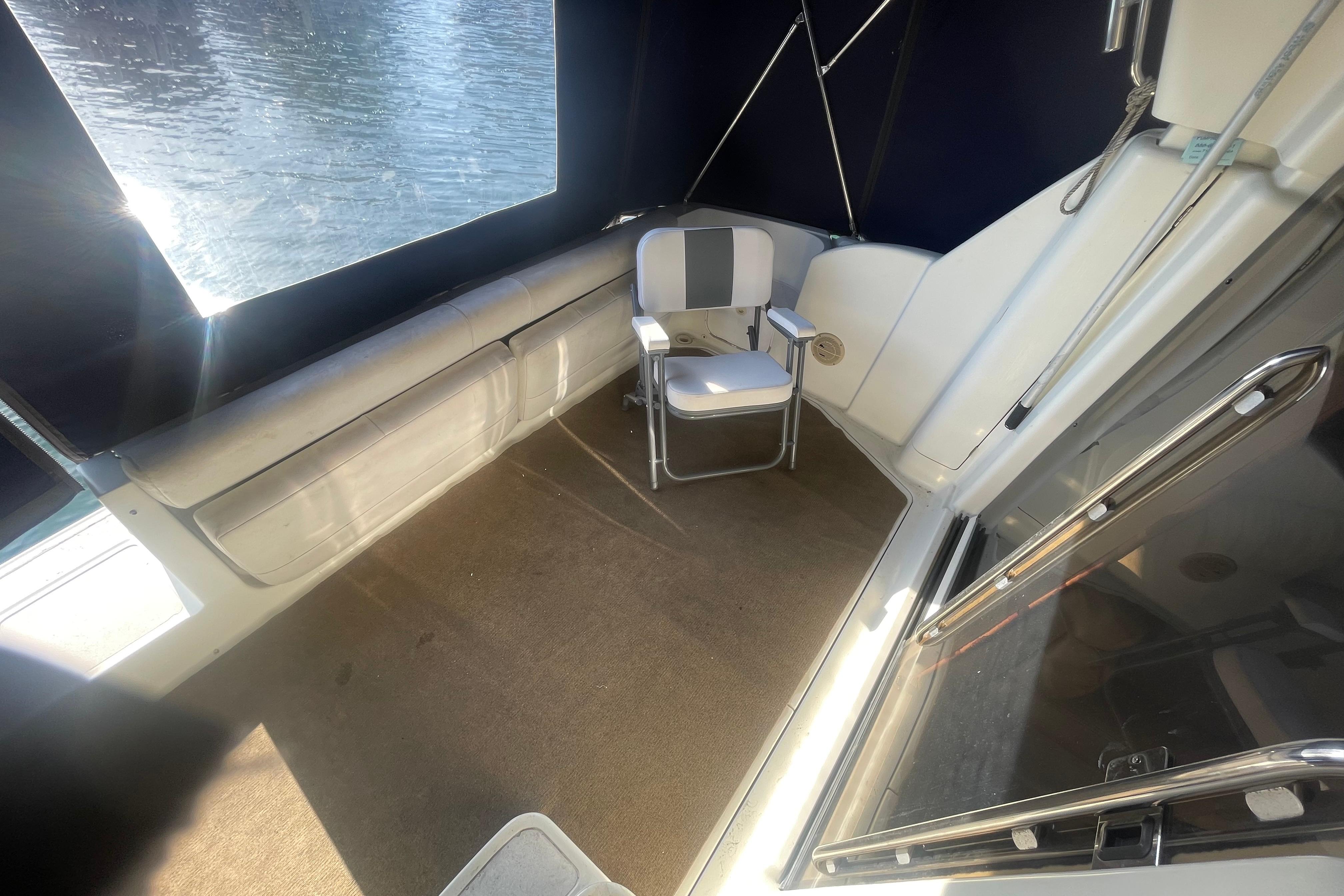 1995 Silverton 36 Convertible boat interior with chair and window view.