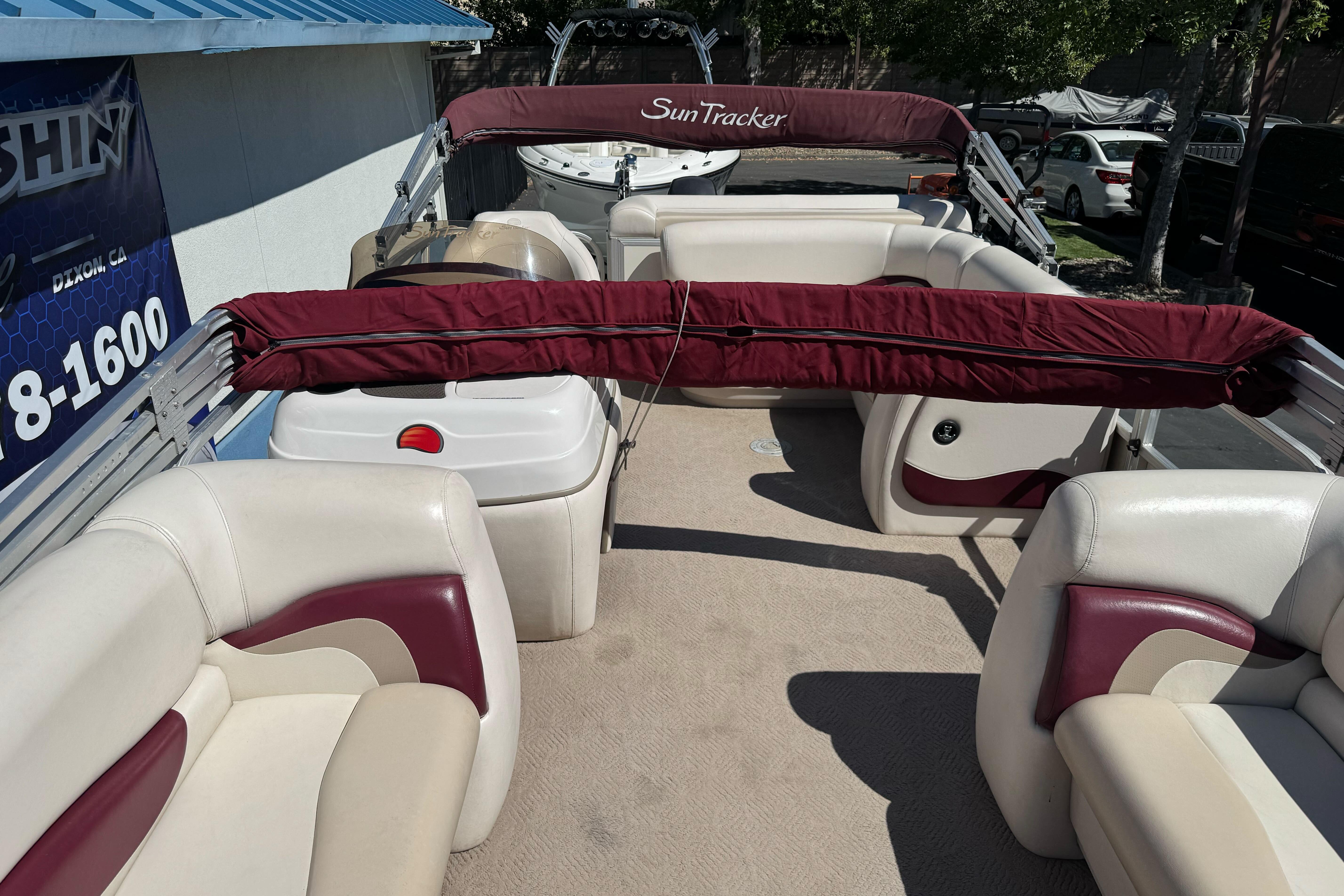 2011 Sun Tracker Party Barge 21 interior with maroon and cream seating.