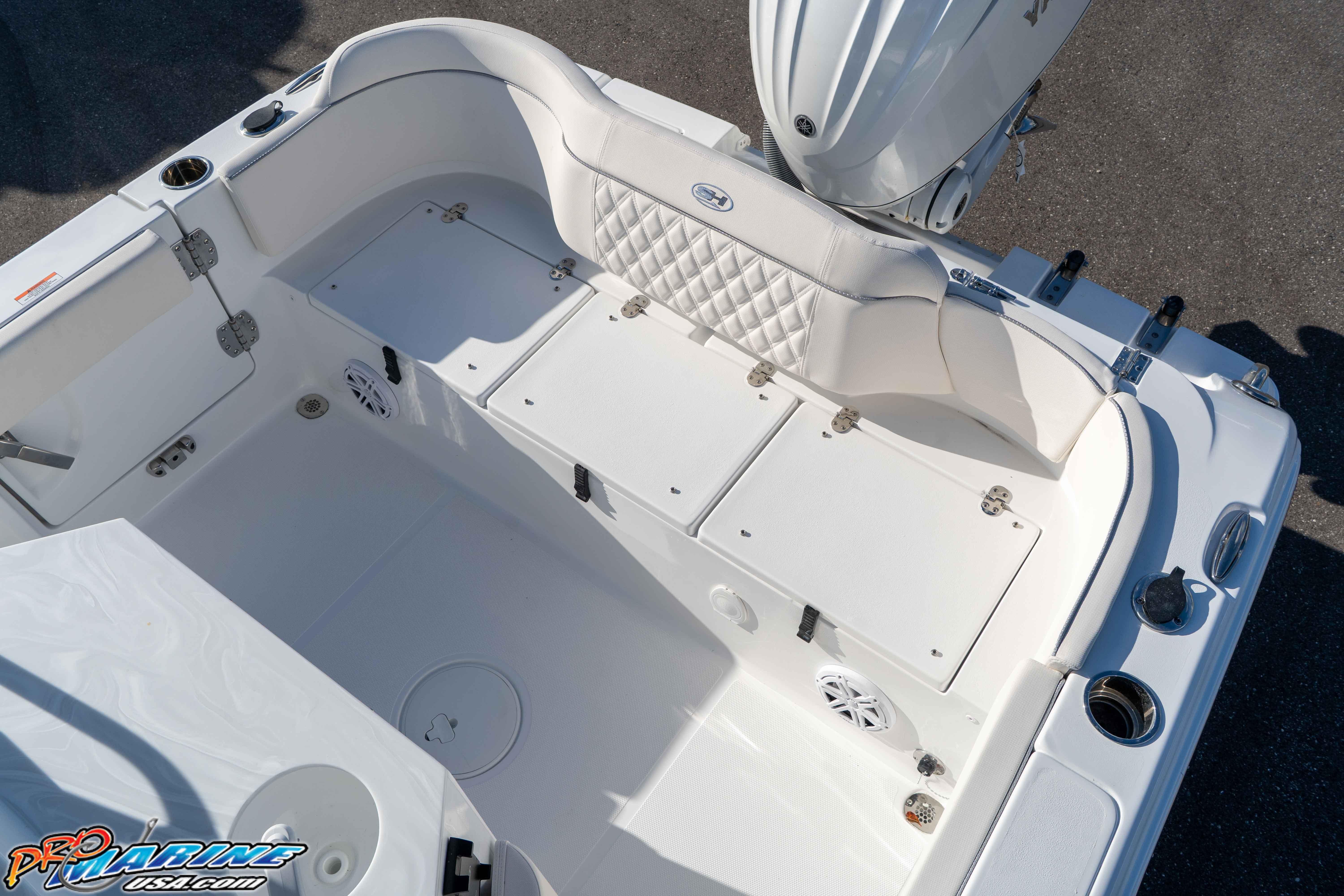 2025 Sea Hunt Ultra 245 SE boat interior with white seating and storage compartments.