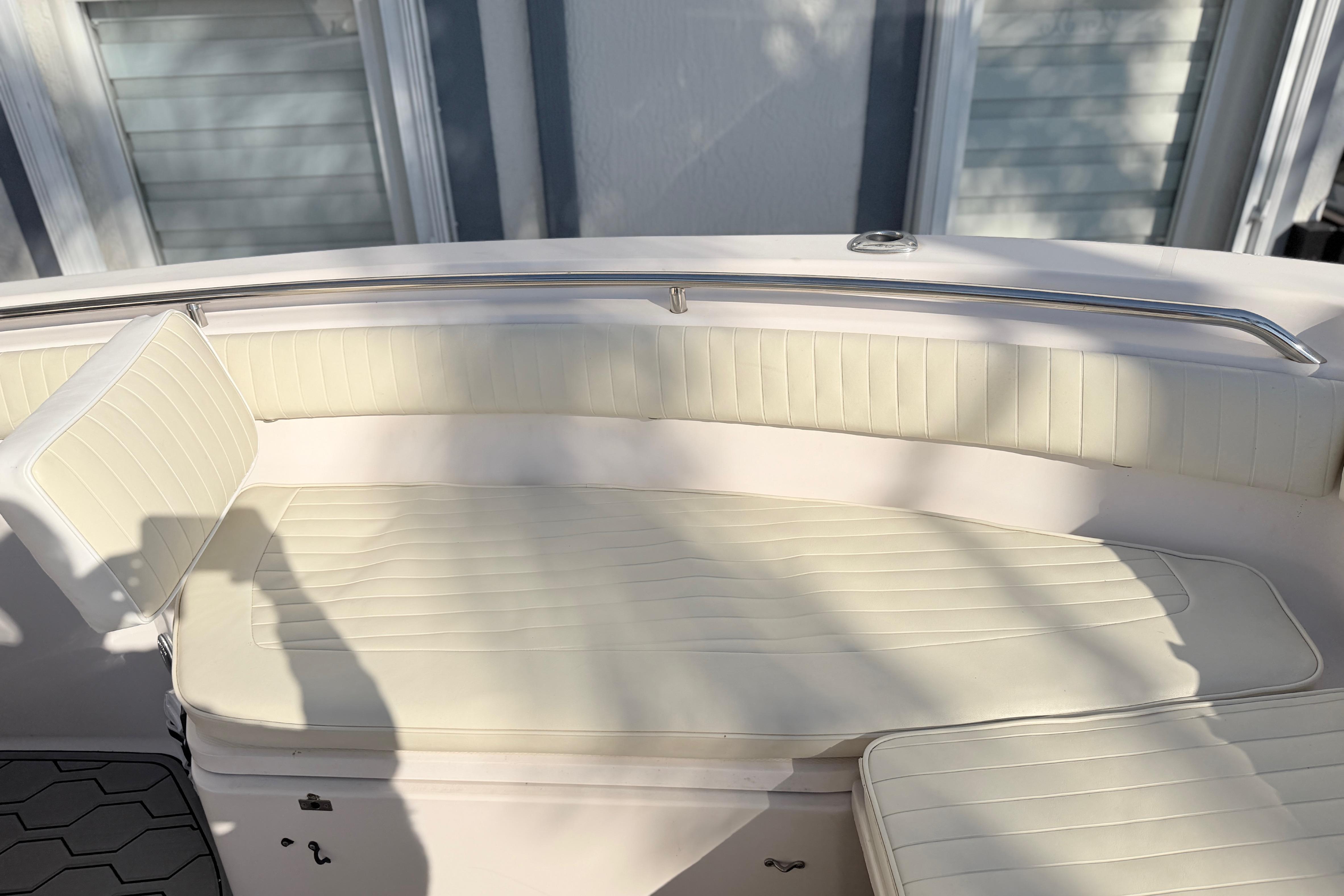 2004 Grady White 273 boat interior with cream seating and stainless steel railing.