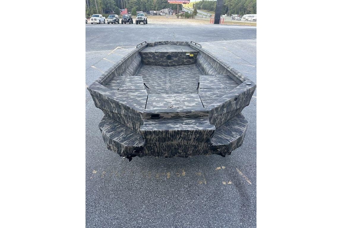 2025 Havoc 1860 boat with camouflage design, parked on asphalt.