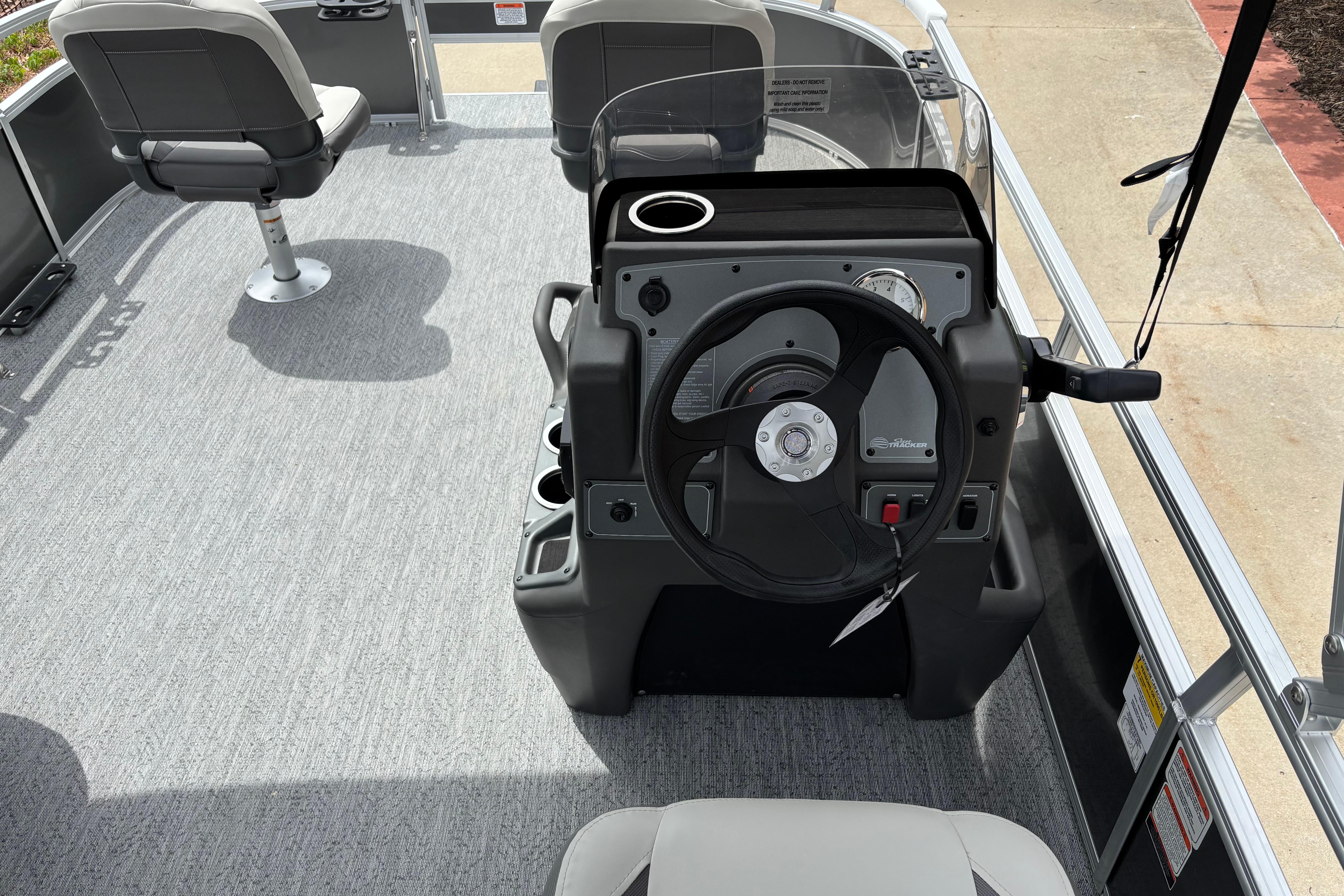 Interior view of 2026 Sun Tracker Bass Buggy 16 XL Select pontoon boat with steering console.