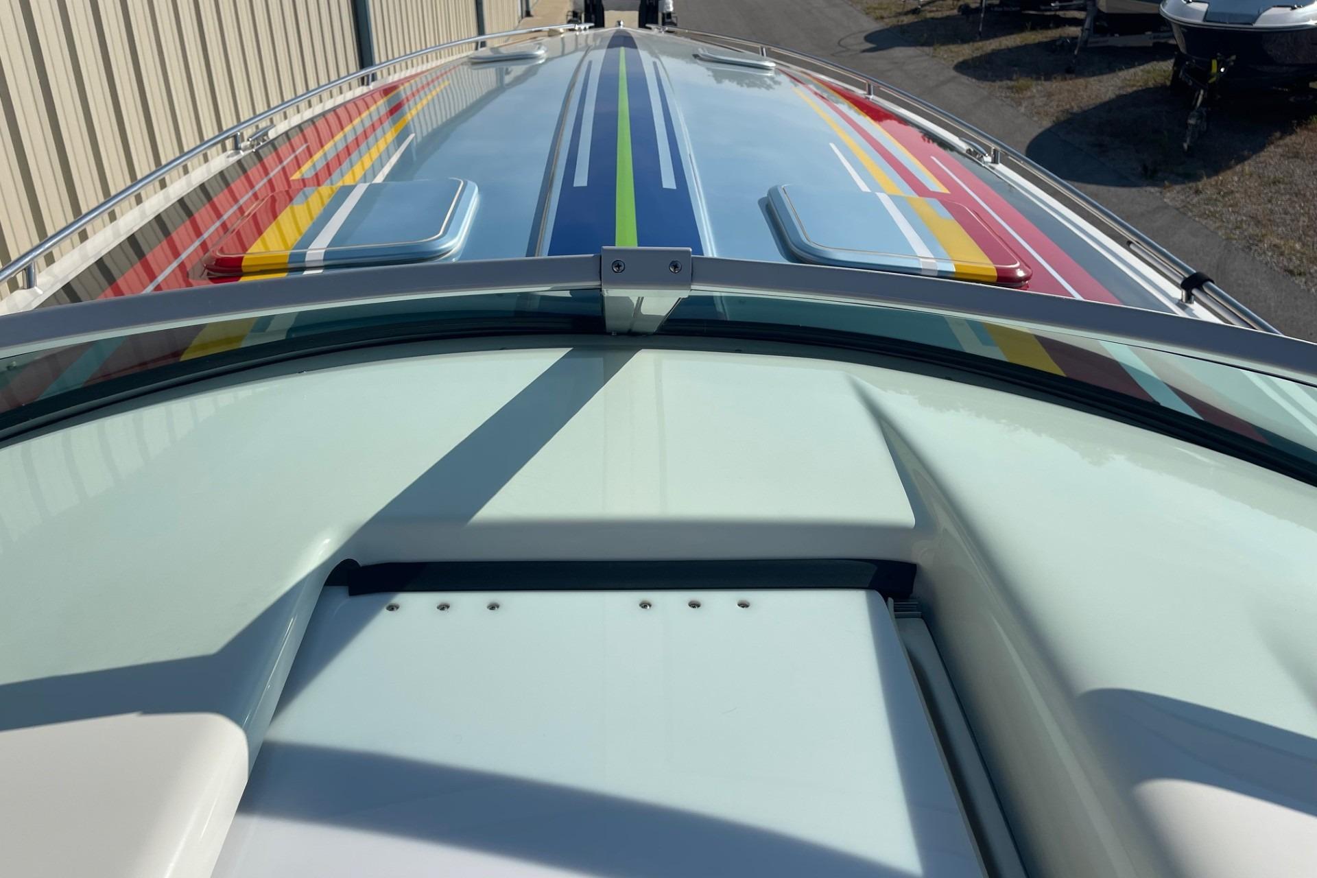 2004 Formula 382 FASTech boat with colorful striped design on deck.