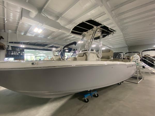 2024 Key West 203 FS boat in showroom, side view, under bright lighting.