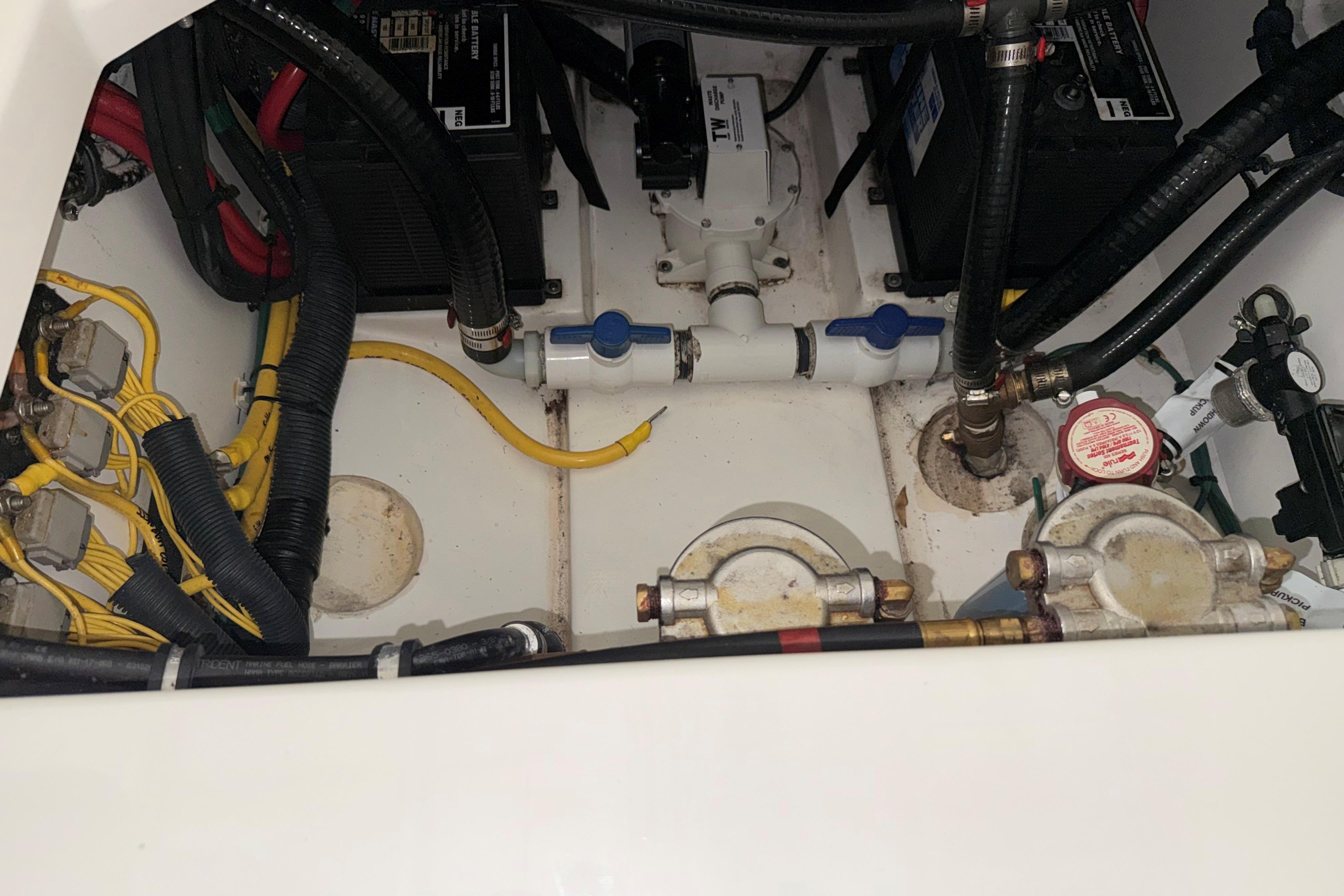 Engine compartment of 2021 Pursuit S 268 Sport boat with wiring and components.