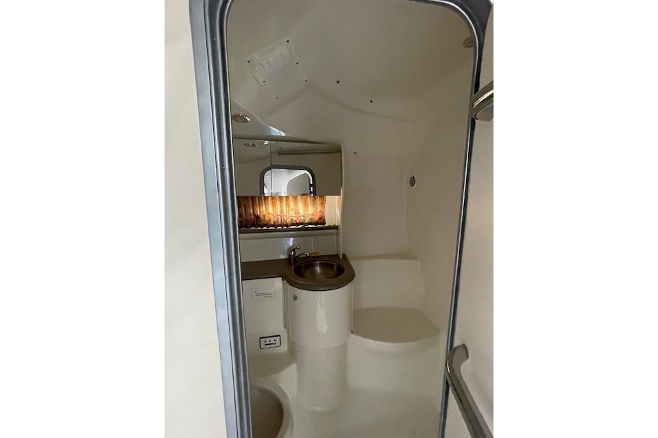 Interior of 1999 Formula 400 Super Sport boat bathroom with sink and mirror.