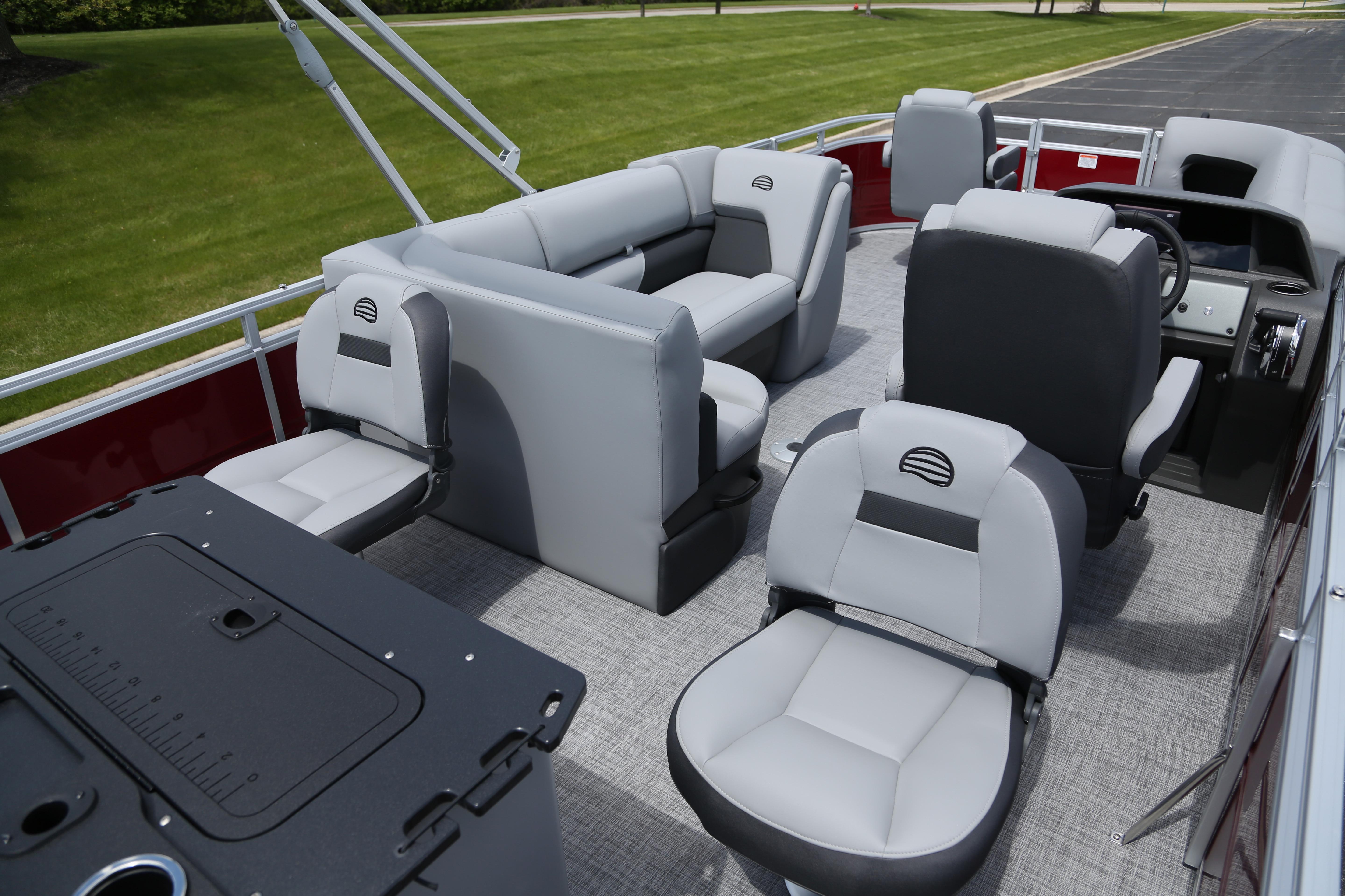2026 Sun Tracker SportFish 20 DLX pontoon boat interior with gray seating and fishing station.