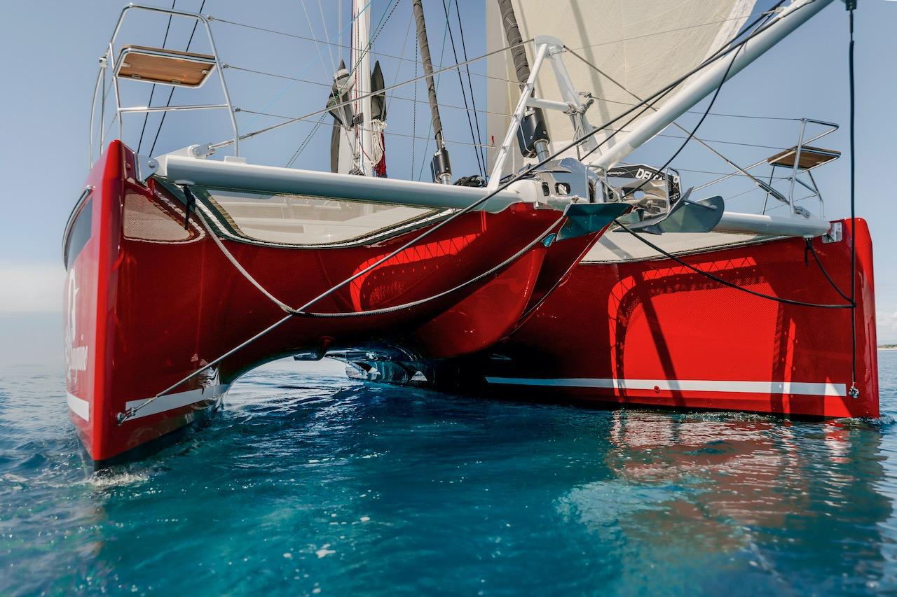 Red Privilege Signature 510 catamaran on clear water, year 2025.