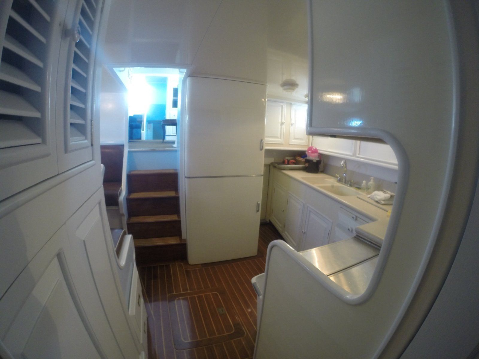 Interior of a 1963 Burger Flush Deck yacht, featuring kitchen and stairs.
