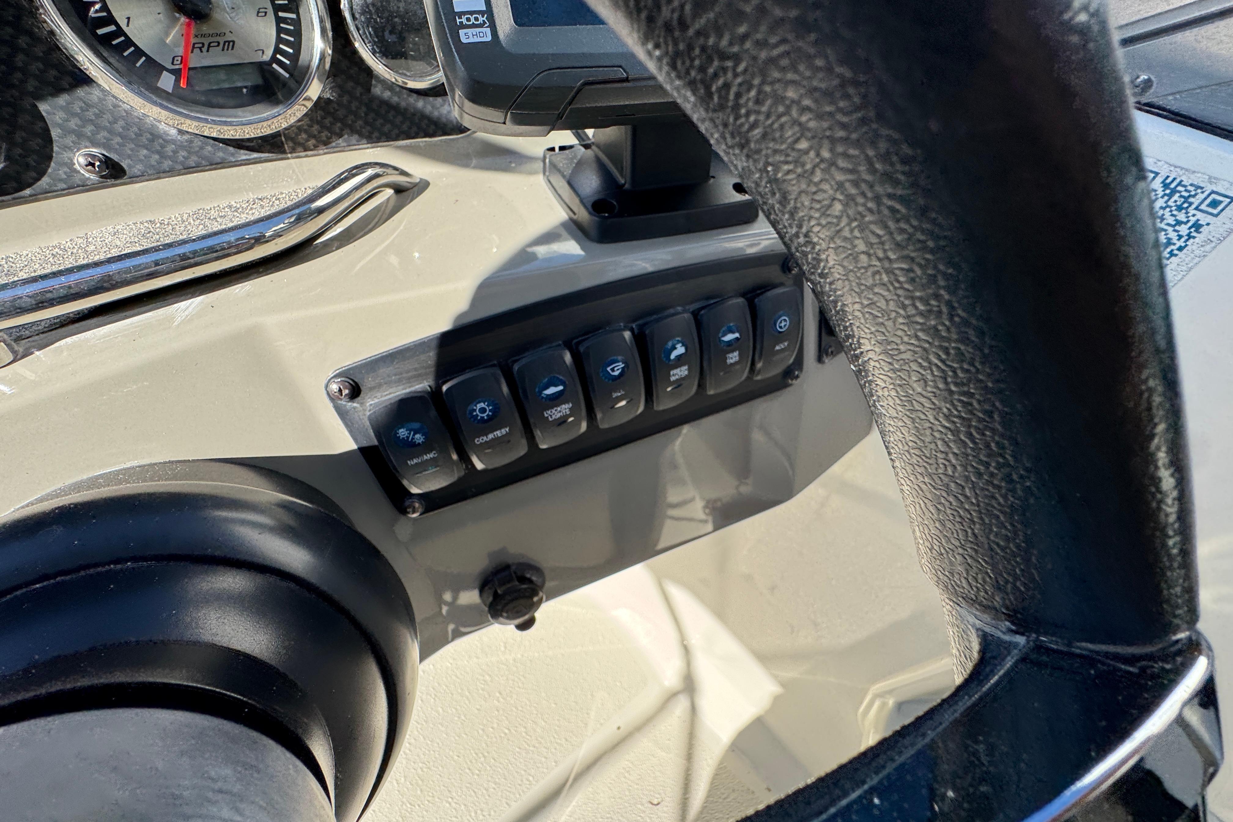 Dashboard controls of a 2018 Stingray 204 LR boat with steering wheel and switches.