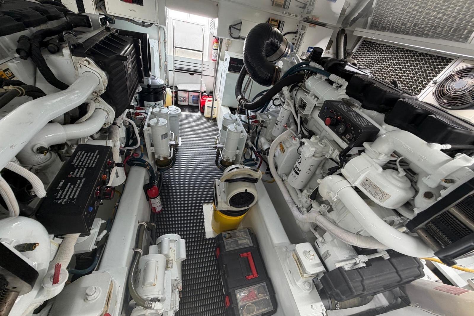 Engine room of 2003 Hatteras 54 Convertible yacht, showcasing dual engines and equipment.