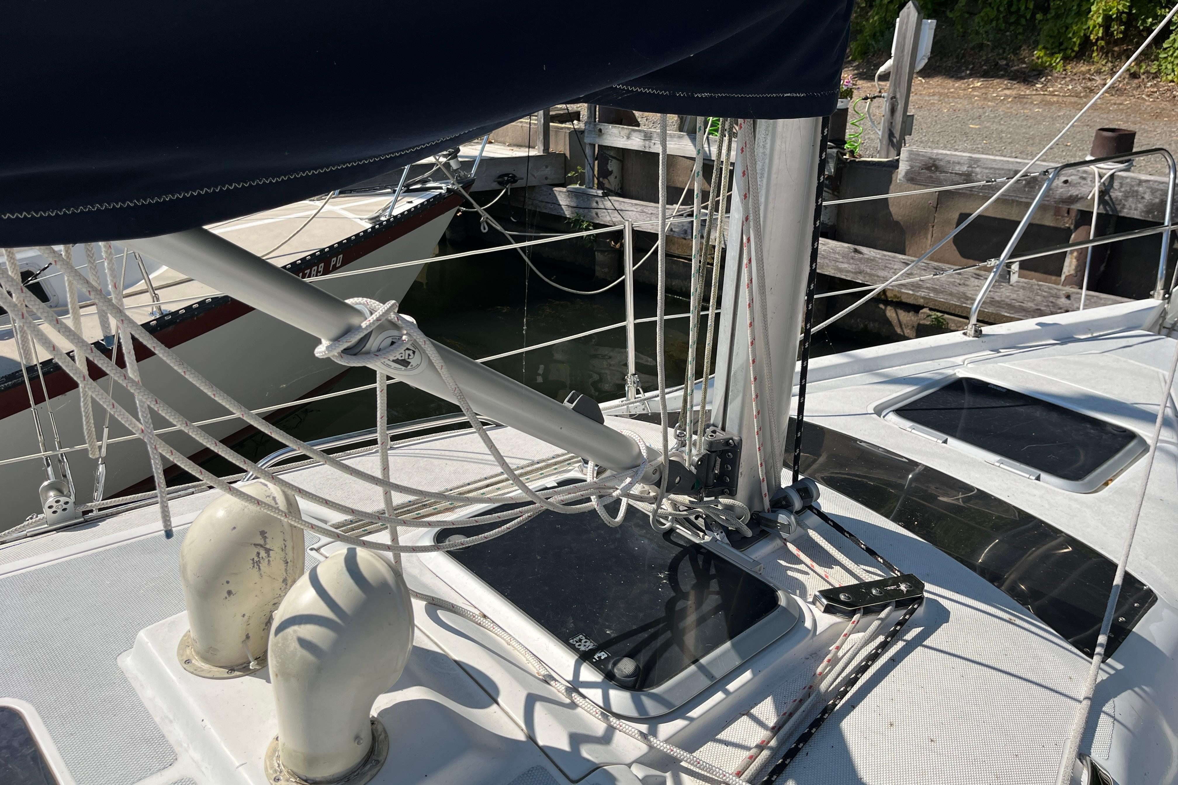 1994 Hunter 29.5 sailboat deck with rigging and hatches in a marina setting.