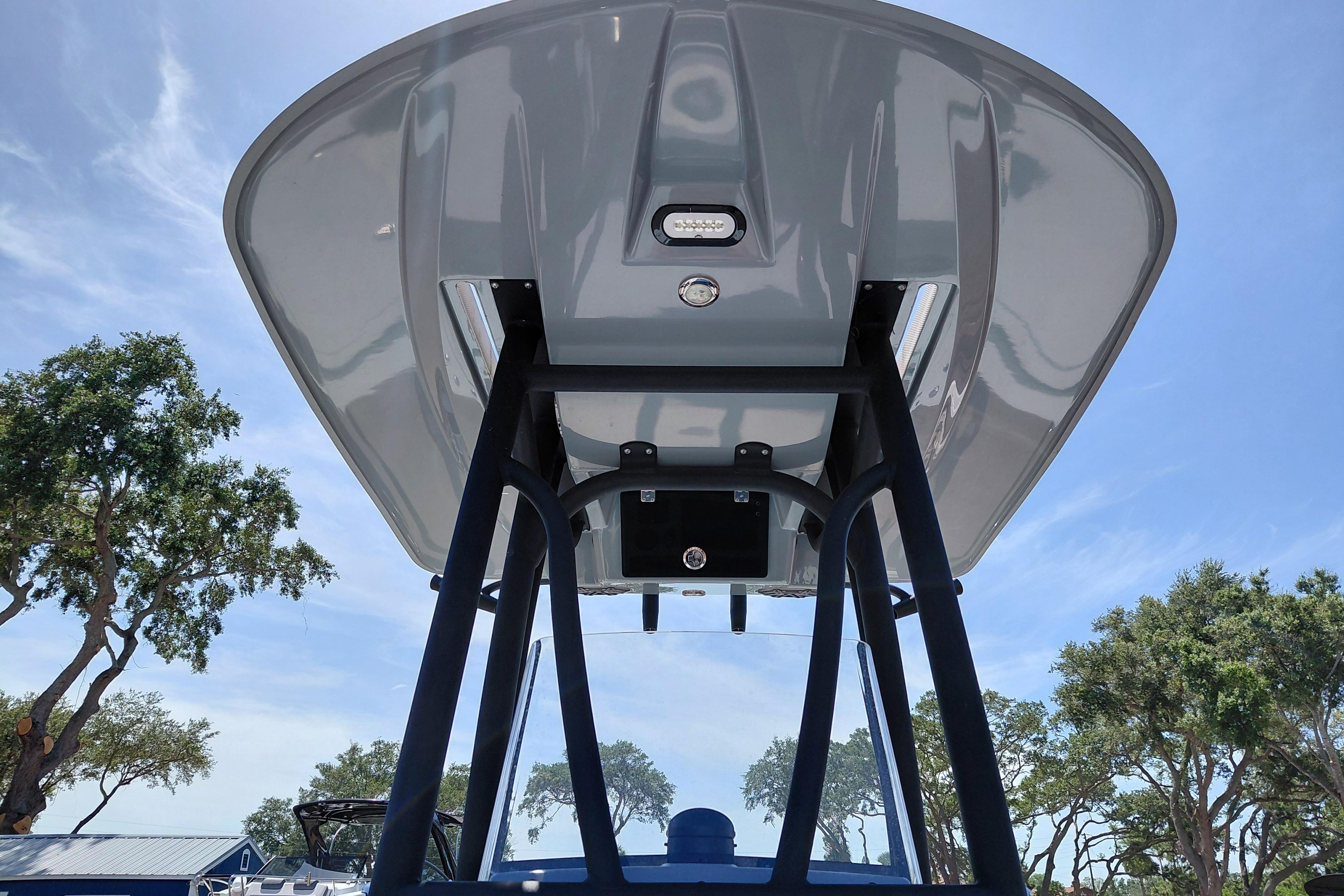 2022 Pathfinder 2300 HPS boat T-top viewed from below, against a clear sky.