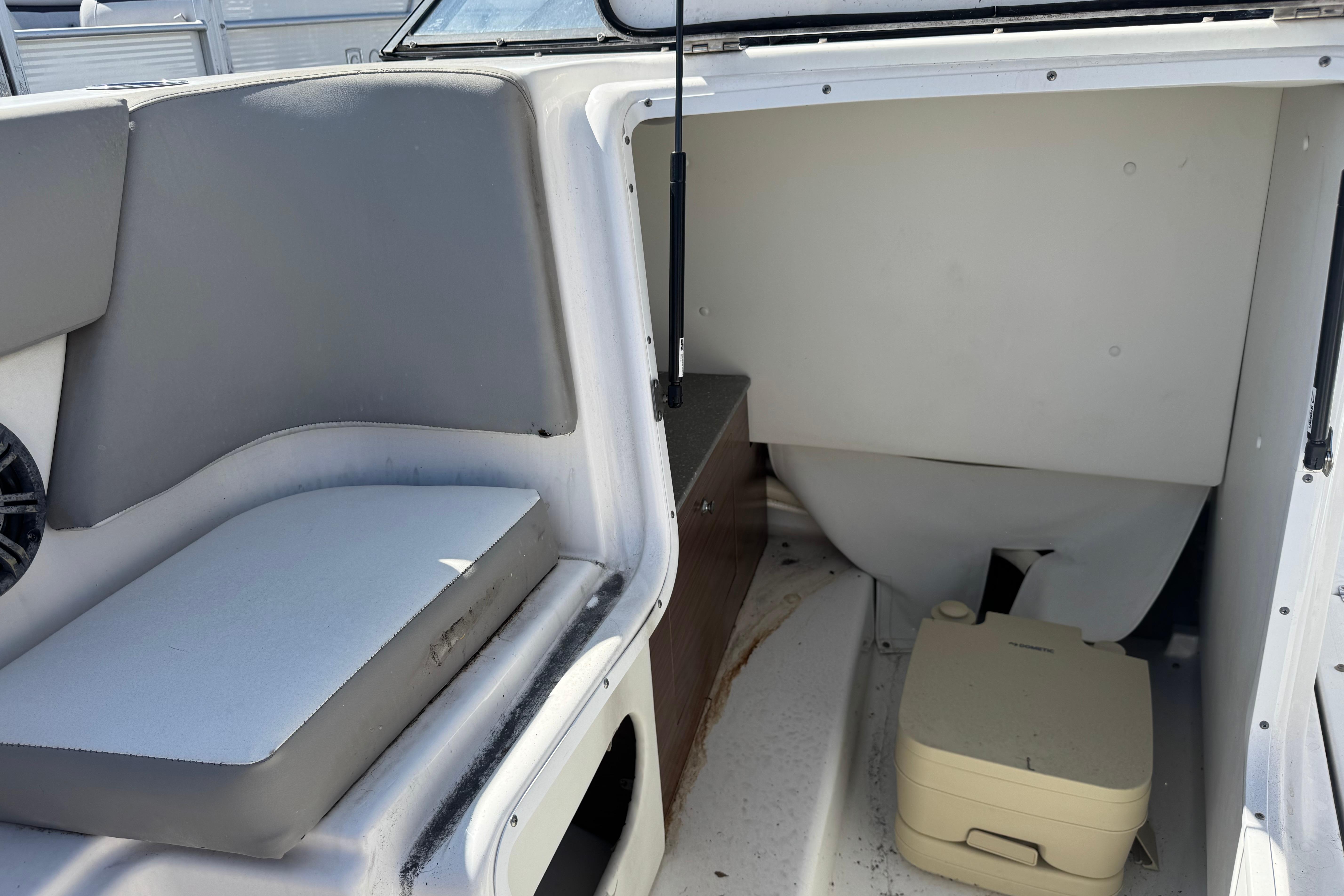 2020 Glastron GTD 240 boat interior with seating and portable toilet.