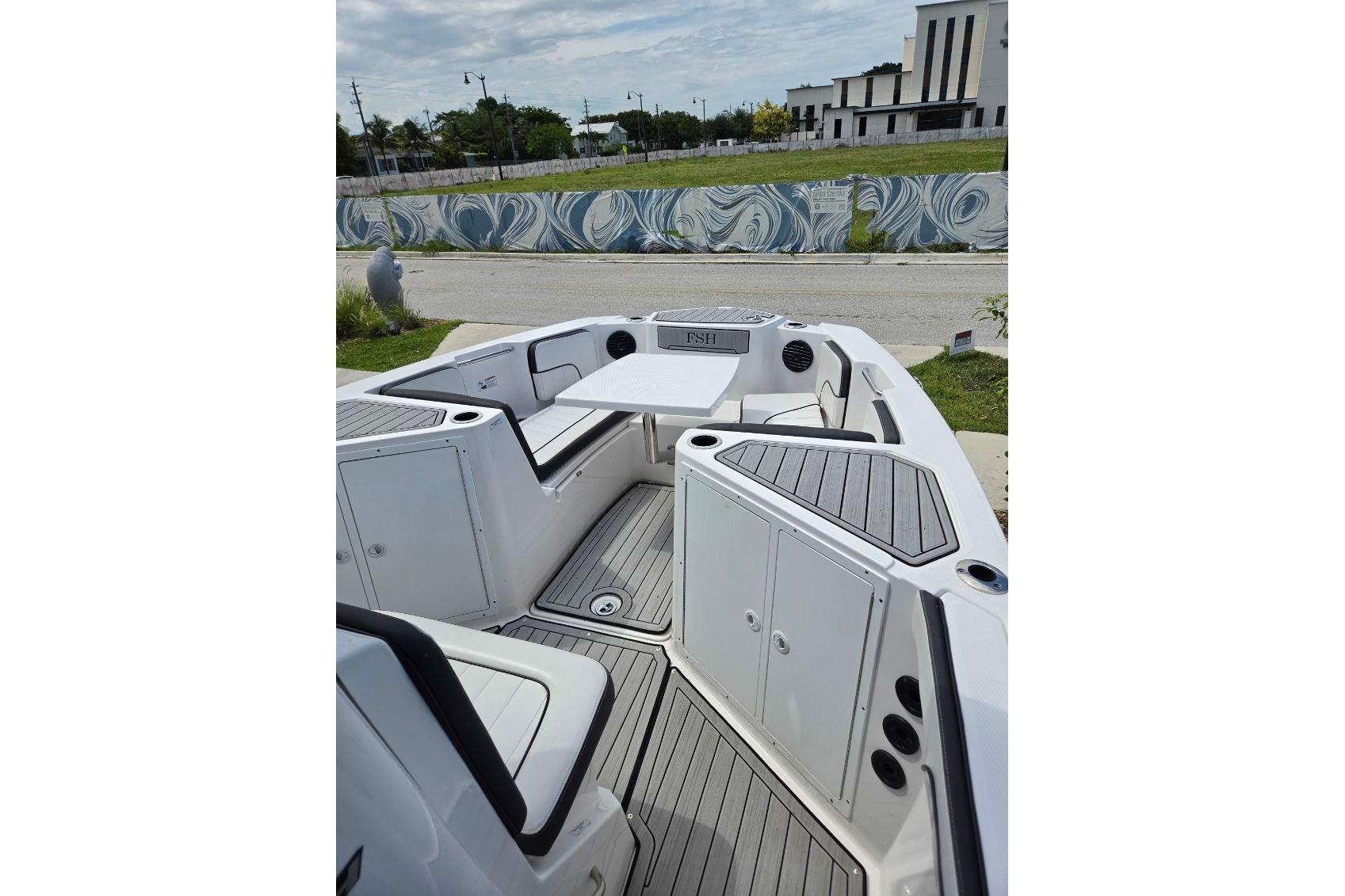 2024 Yamaha Boats 222 FSH Sport E interior with seating and storage compartments.