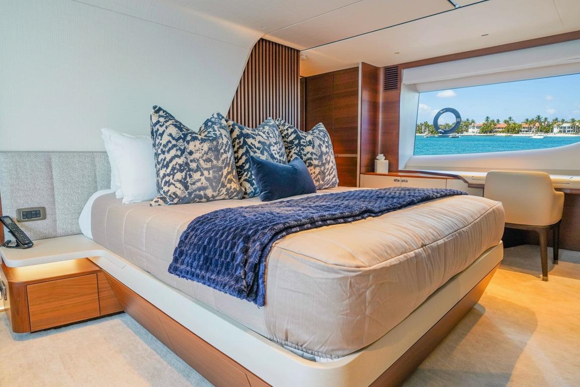 Luxurious bedroom interior of 2021 Princess Y85 yacht with ocean view.