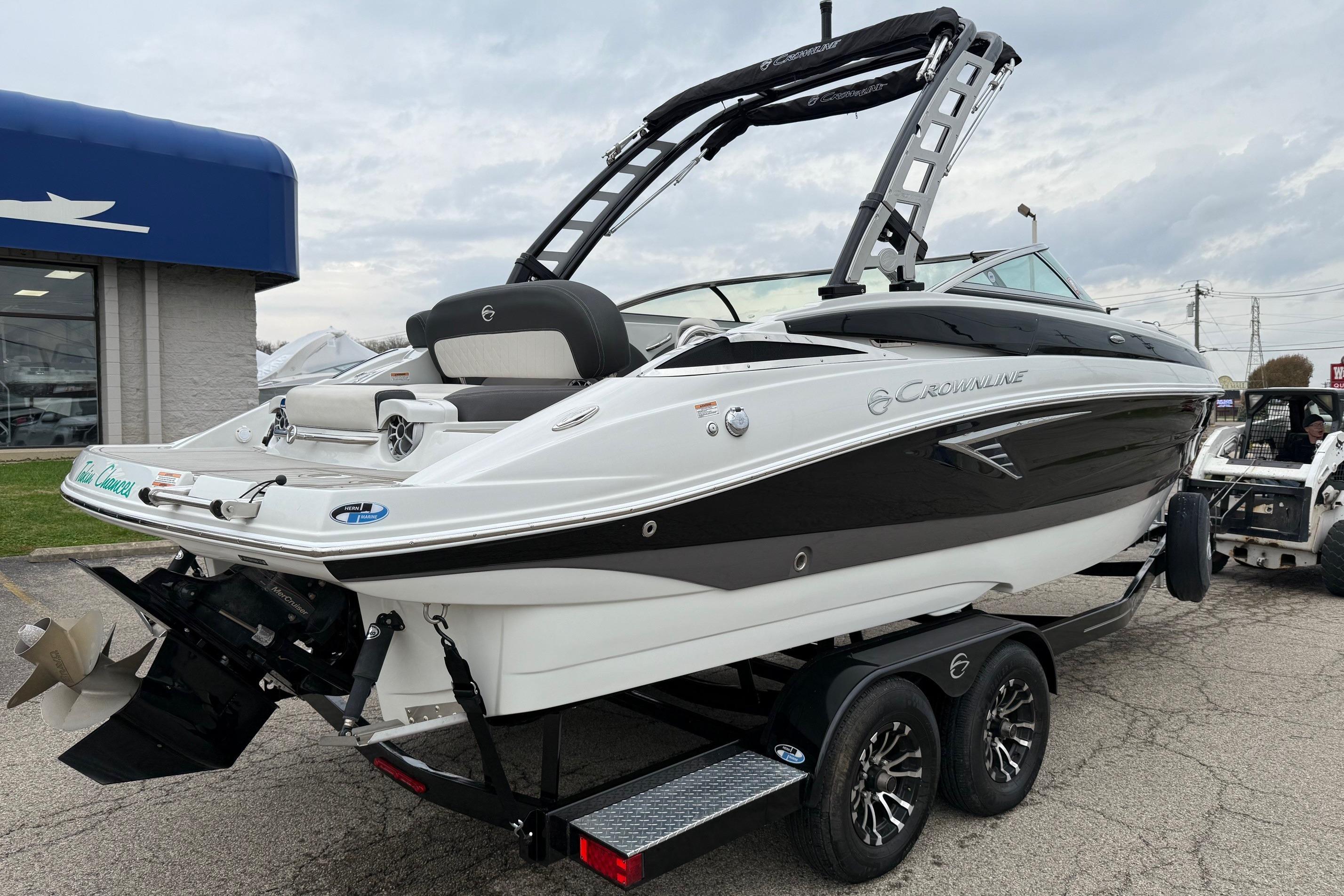 2022 Crownline 255 SS boat on trailer, sleek design, black and white exterior.