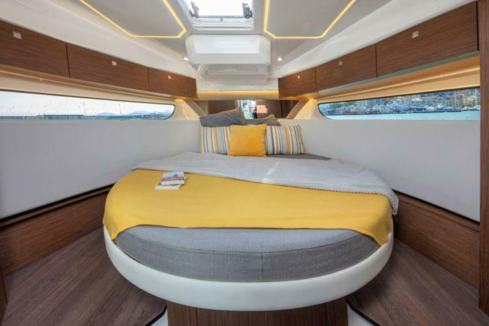 Luxurious cabin interior of 2025 Jeanneau NC 1095 Fly with modern design and cozy bedding.