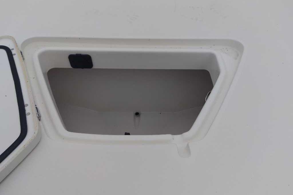 Open storage compartment on a 2026 Mako 18 Pro Skiff boat.