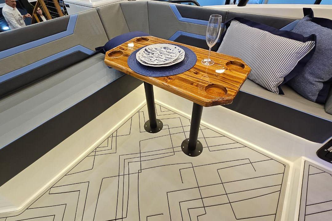 Luxurious Hanover 327 boat interior with elegant wooden table, plush seating, and stylish decor, 2026 model.