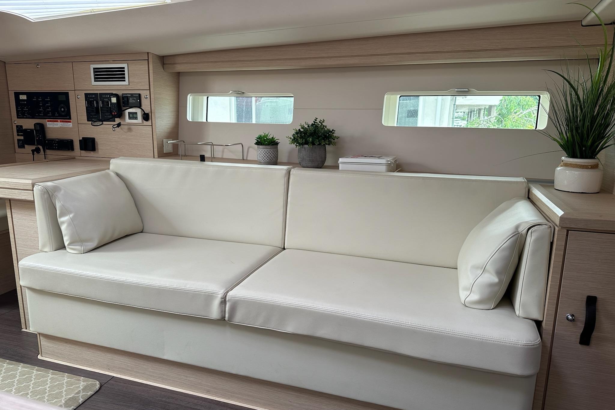 Interior of 2018 Jeanneau 51 yacht with white sofa and modern decor.