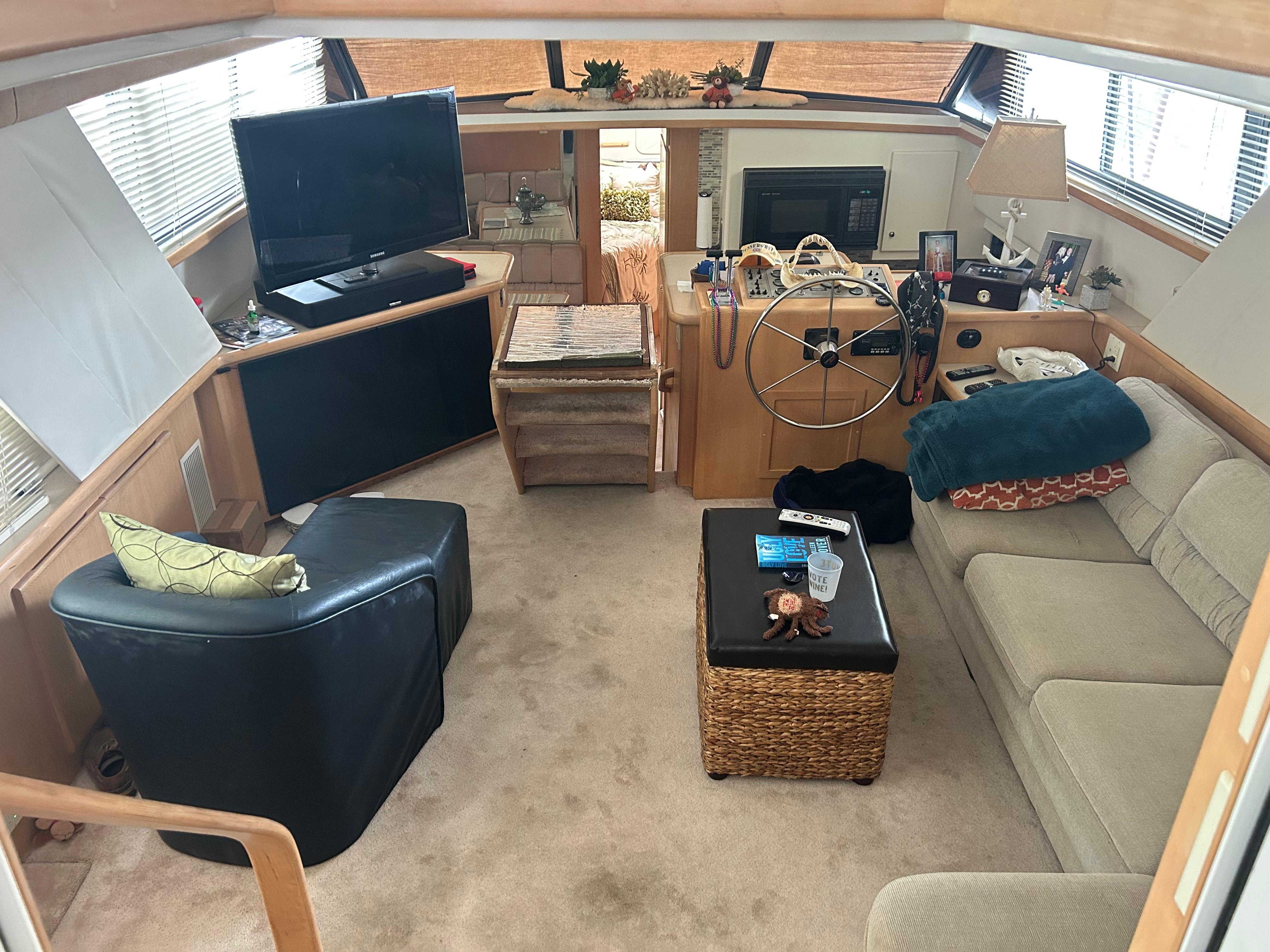 Interior of 1996 Carver 440 Aft Cabin Motor Yacht, featuring cozy seating and entertainment area.