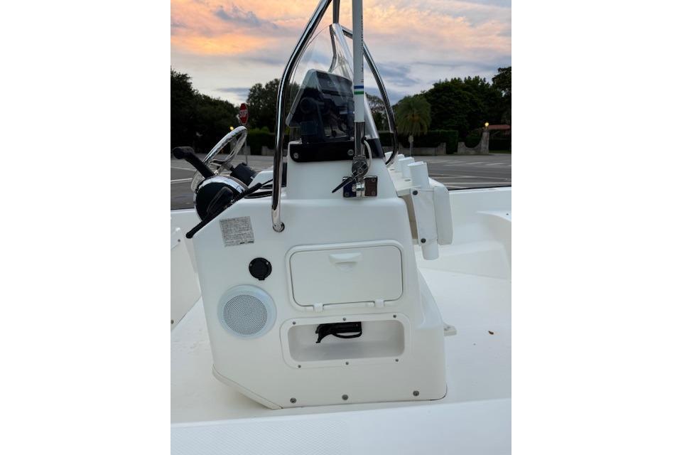 2016 Boston Whaler 150 Montauk boat console at sunset, featuring steering and controls.