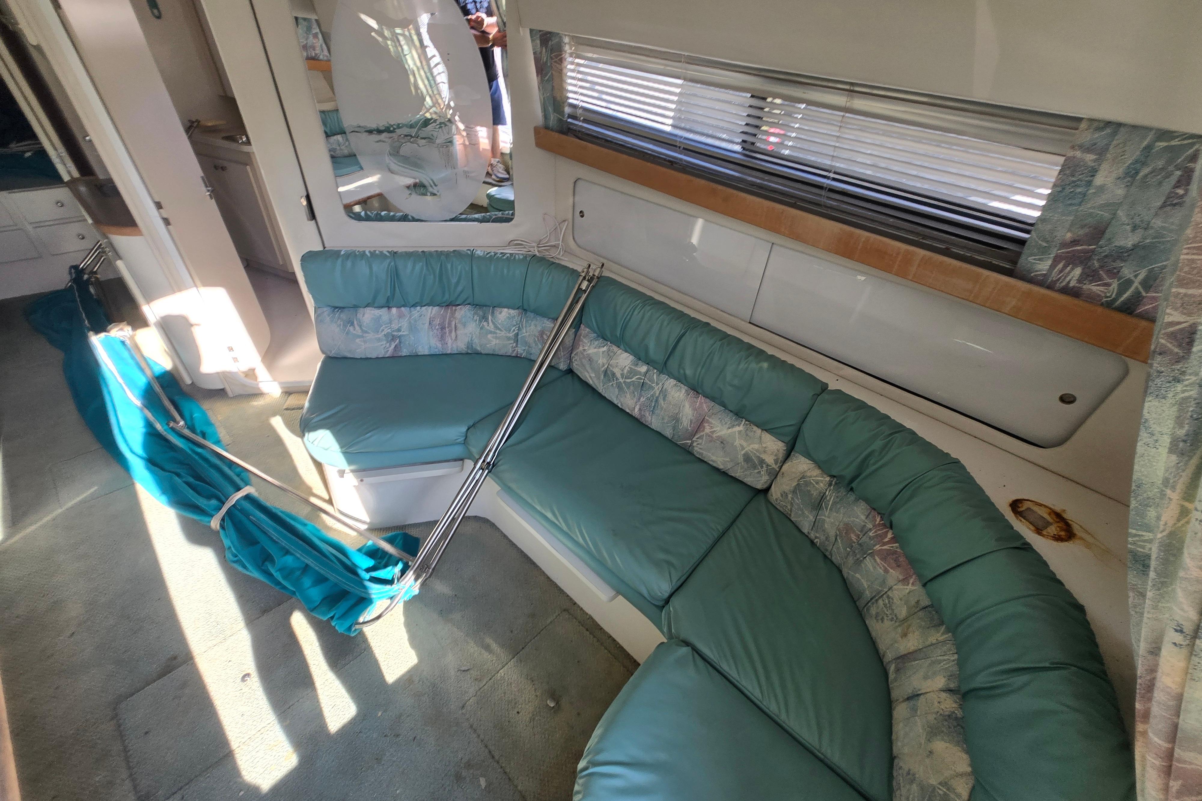 Interior of 1994 Carver 380 Santego yacht with teal seating and modern decor.