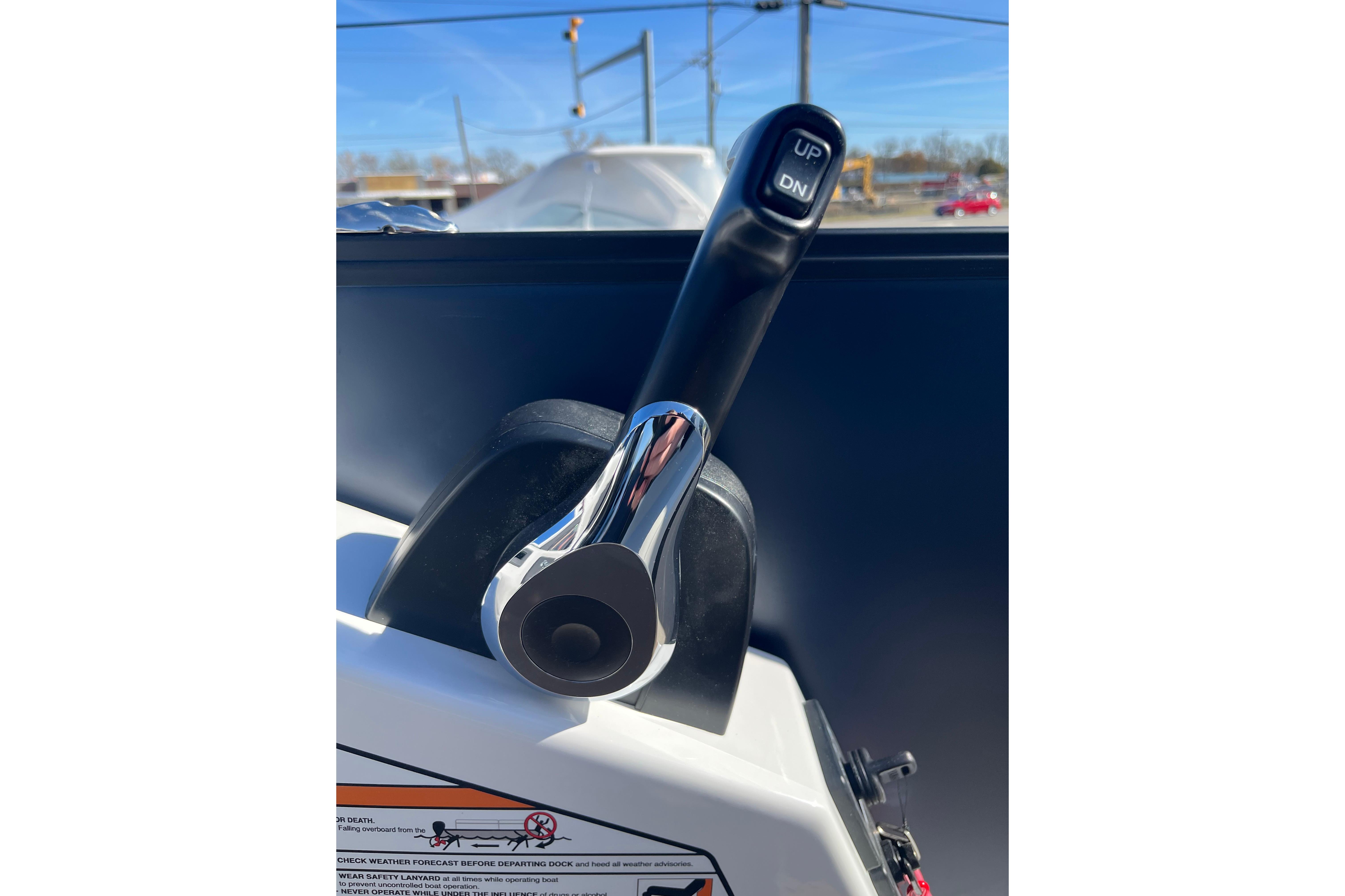 Close-up of Evotti 523CS 2026 boat throttle lever with "UP" and "DN" buttons.