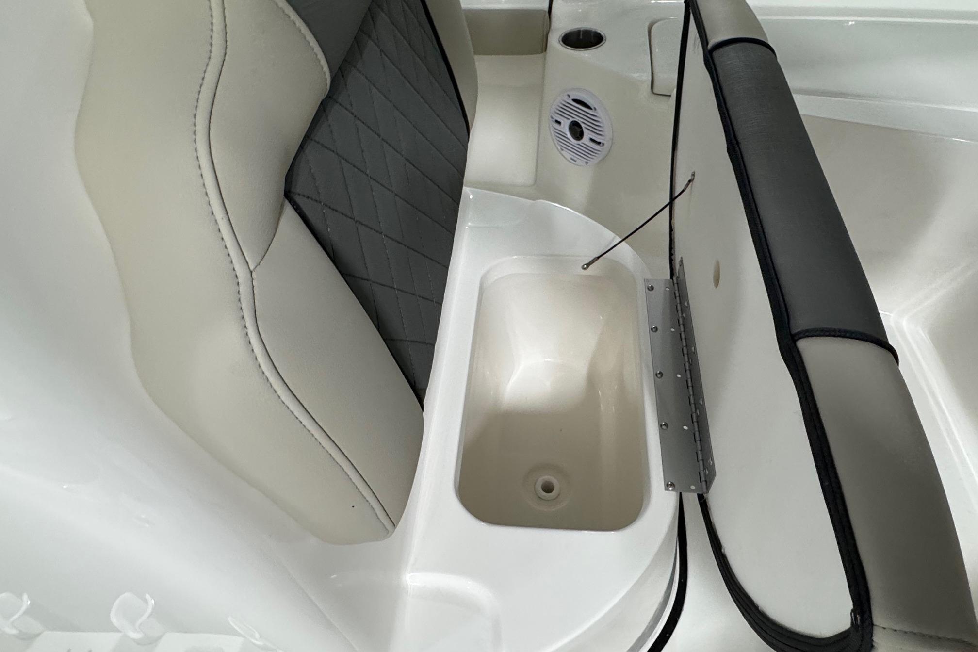 2026 Key West 210 Bay Reef boat seat with storage compartment and speaker.