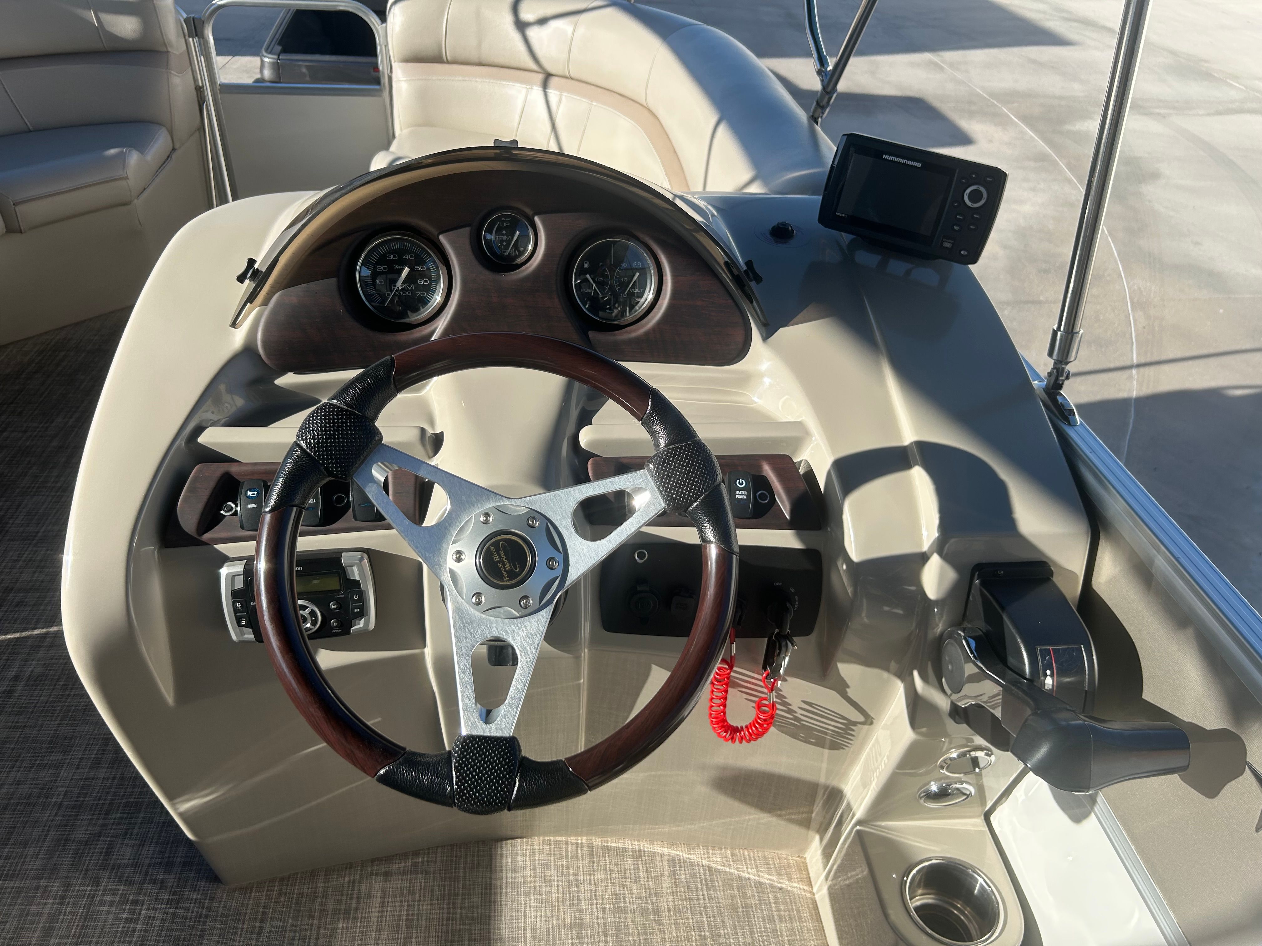 The image shows the helm of a 2018 Berkshire 24RFX CTS pontoon boat with a modern steering wheel and instruments.