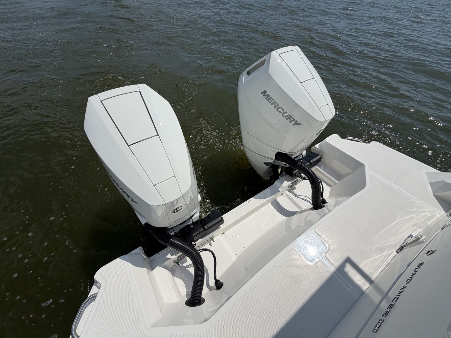2026 Sea Ray Sundancer 320 with Mercury outboard engines on water.
