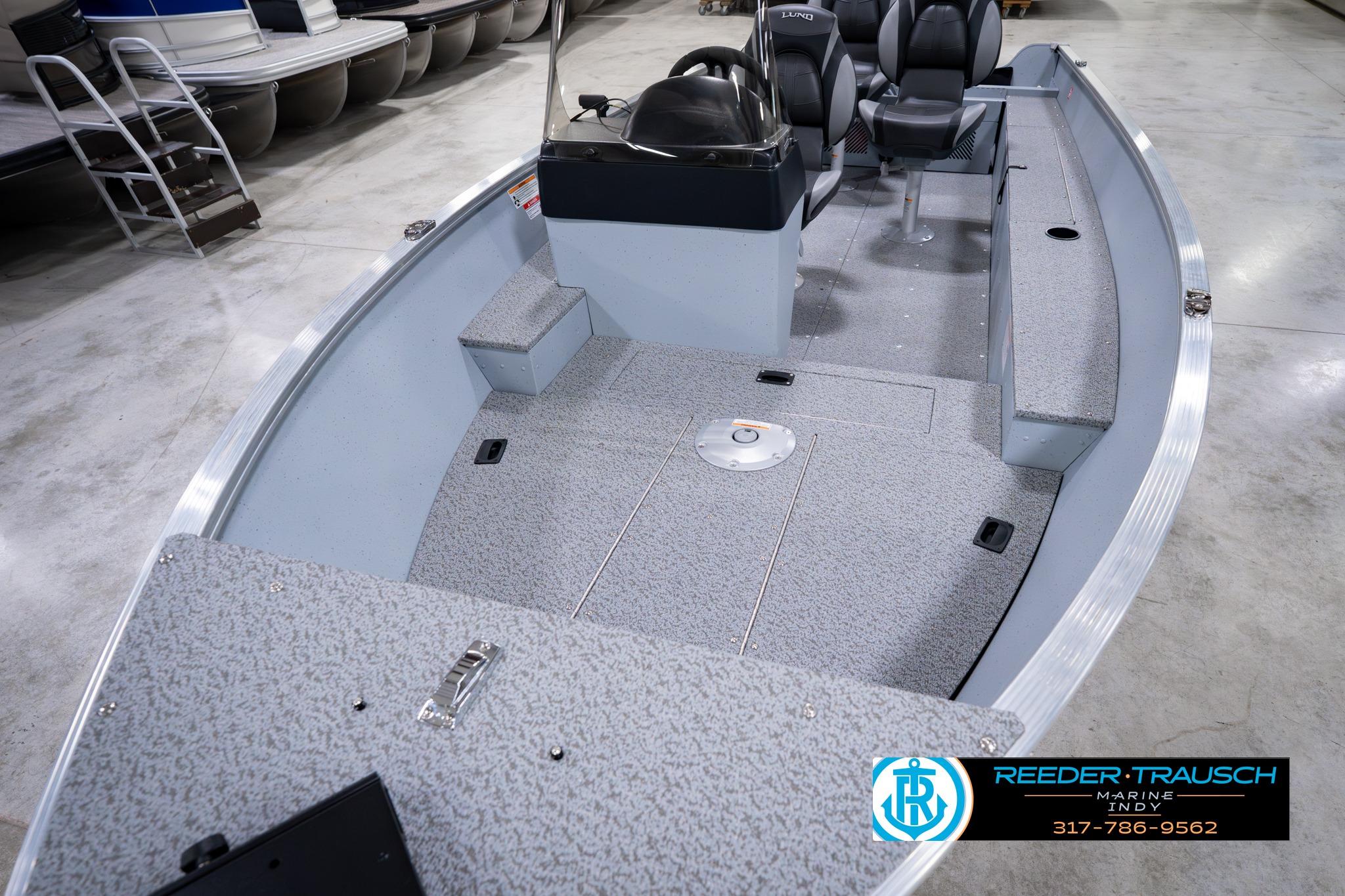 2026 Lund 1600 Fury SS fishing boat interior with seating and steering console.