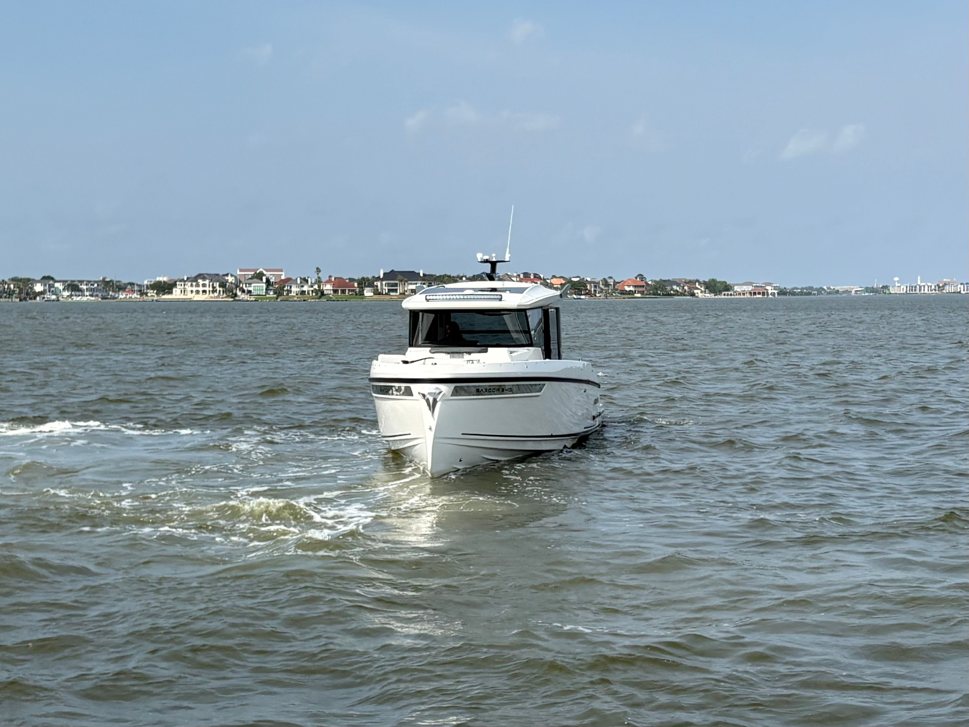 Saxdor 340 GTWA 2026 cruising on calm waters near coastline.