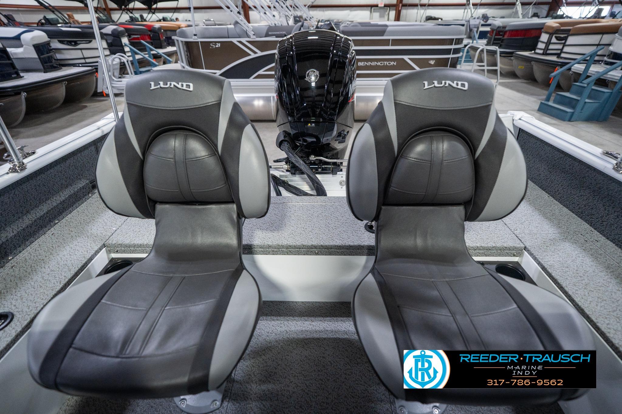 2026 Lund 1700 Explorer Sport boat seats with logo, displayed in showroom.