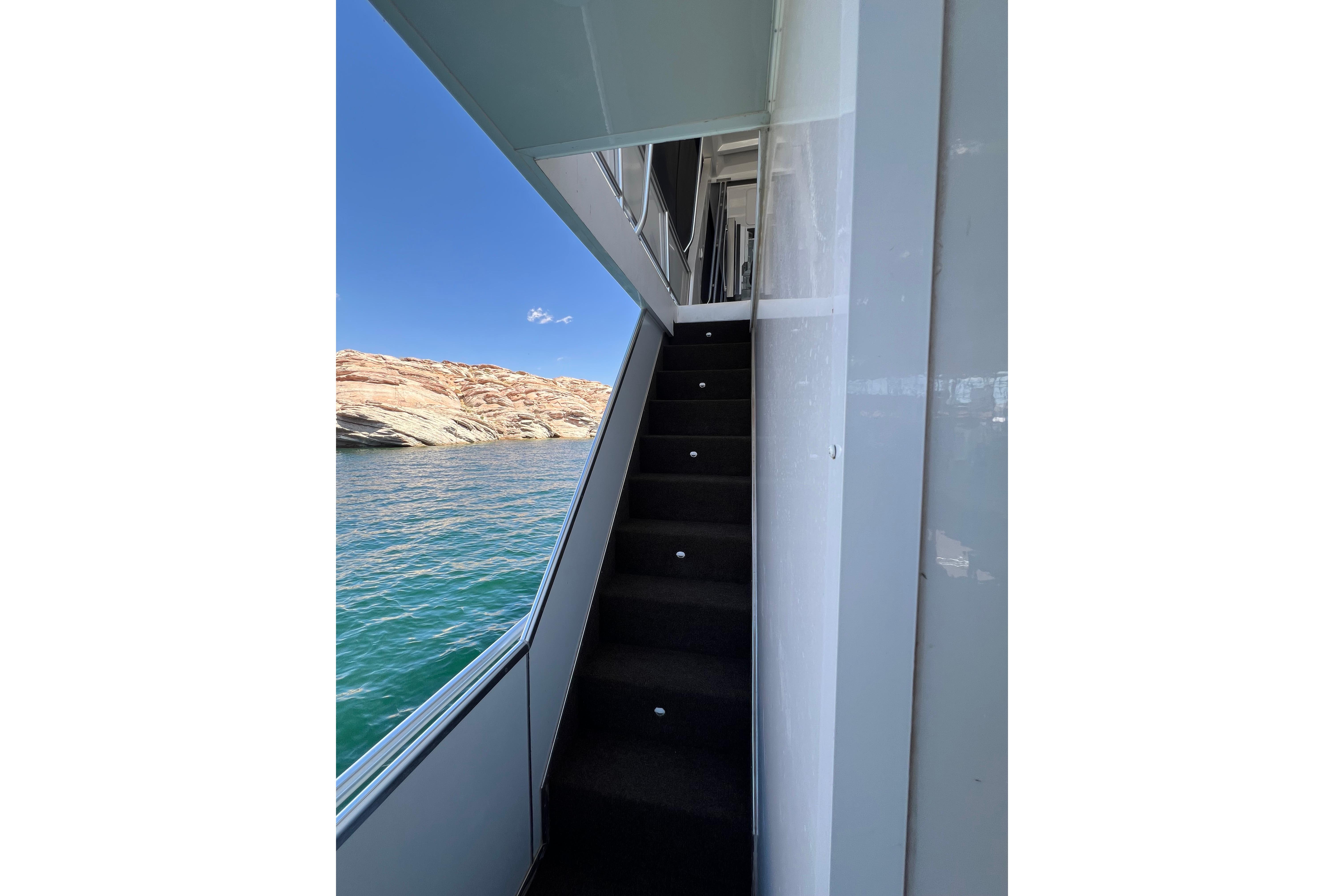 Staircase on 2025 Sumerset Excellence Multiple Shares houseboat with scenic water and rock view.