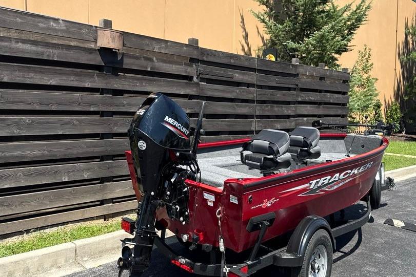 2025 Tracker Super Guide V-16 T boat with Mercury engine, parked outdoors.