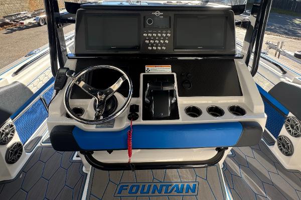 2024 Fountain 34 SC boat dashboard with steering wheel and control panel.