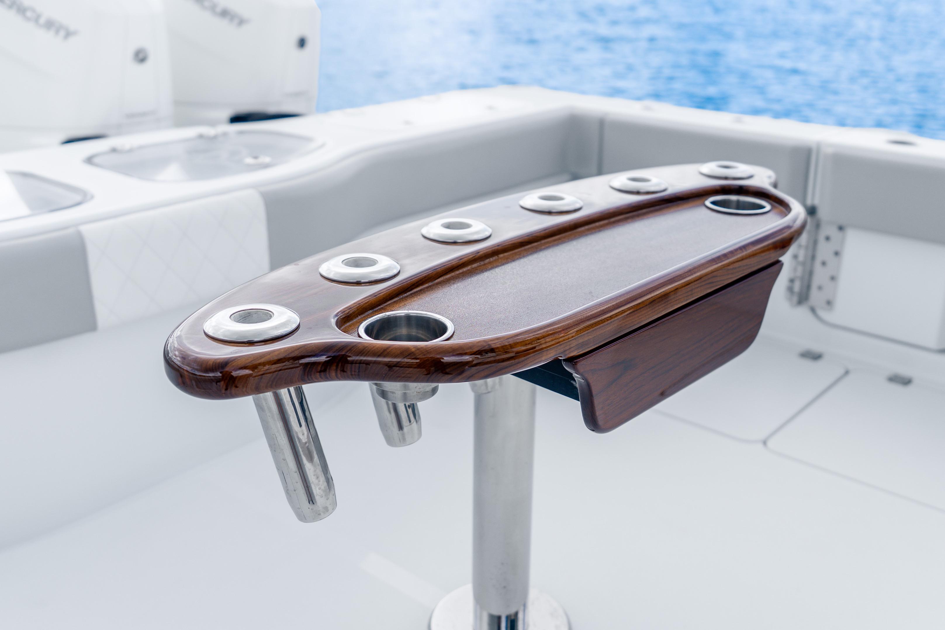 Luxury fishing rod holder on Freeman 47 boat, 2024 model, with ocean backdrop.