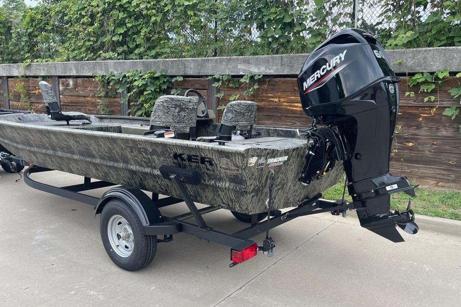 2026 Tracker Grizzly 1754 SC boat with Mercury engine on trailer, parked outdoors.