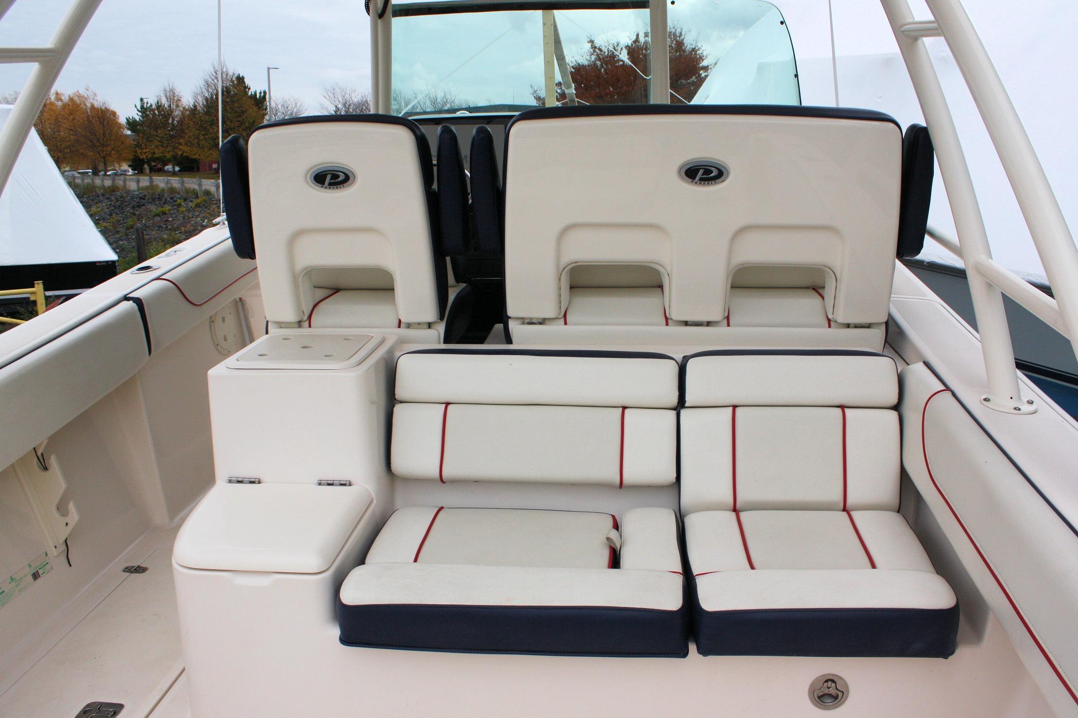 2013 Pursuit ST 310 Sport boat interior with cushioned seating and storage compartments.
