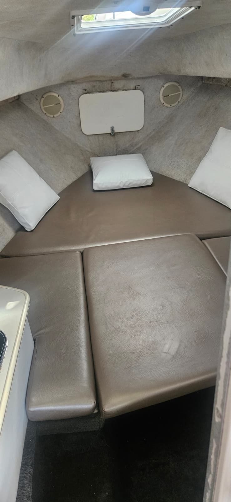 Interior of 2000 Wellcraft 24 Walkaround with cushions and pillows.