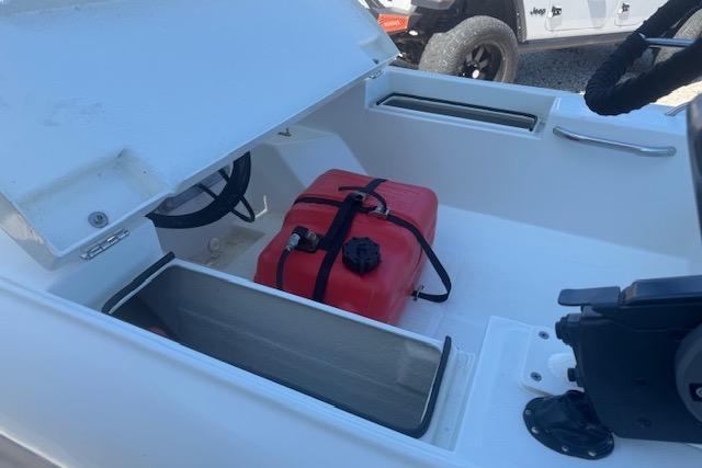 2024 Rigid Boats 10 Sport interior with open storage and red fuel tank.