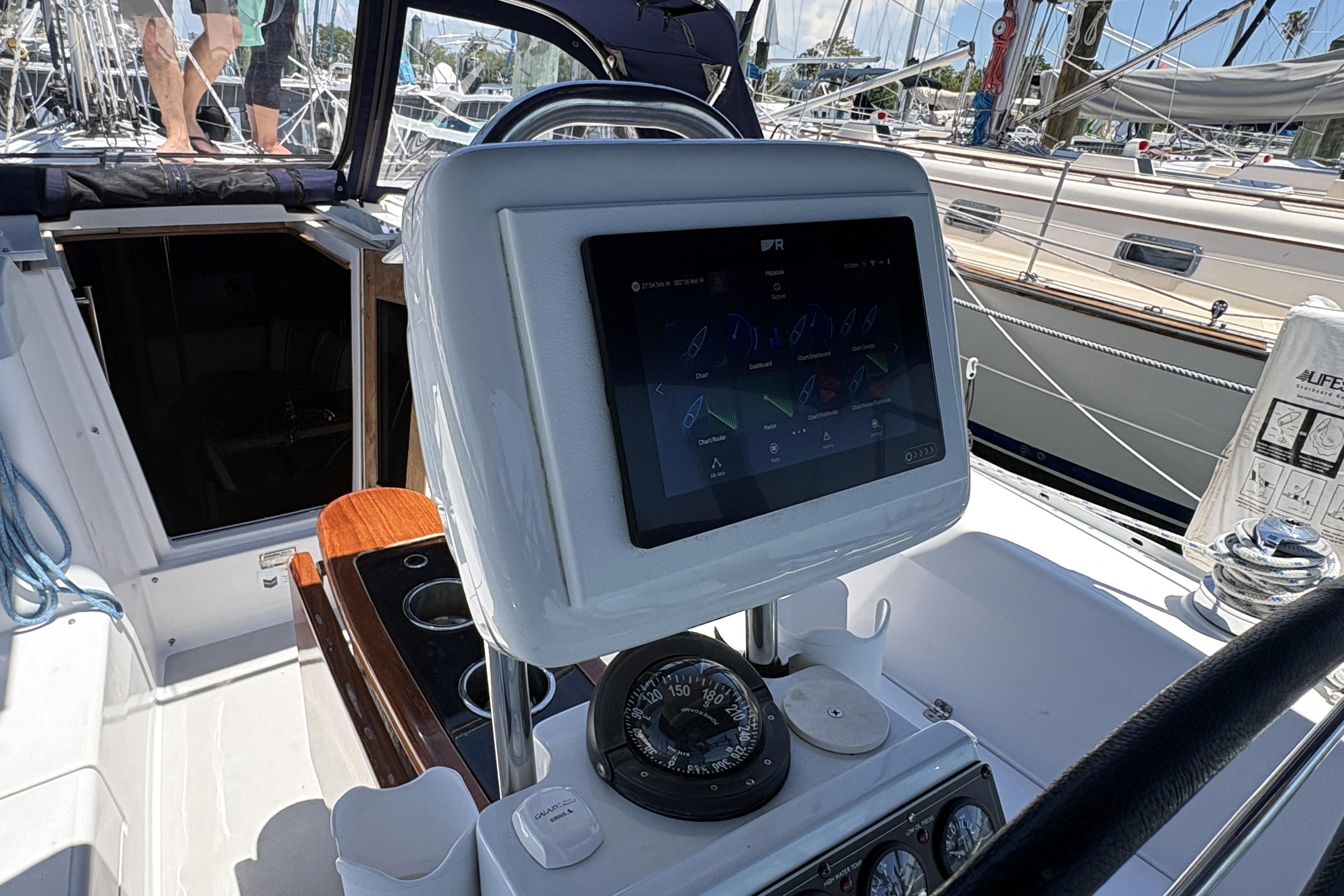 Cockpit of 2011 Catalina 355 sailboat with navigation display and compass.