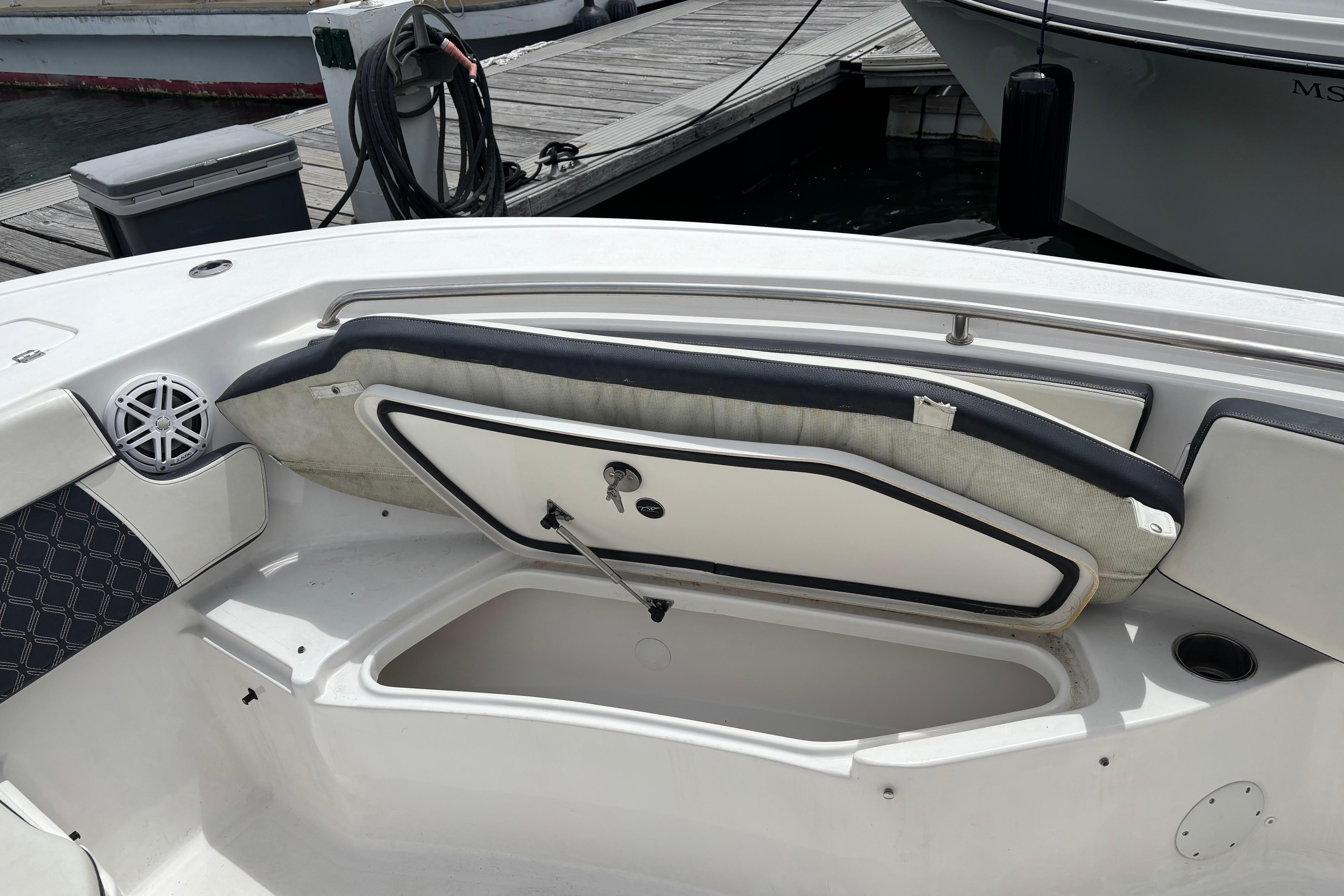 2024 Tidewater 220 CC Adventure boat with open storage compartment and speaker detail.