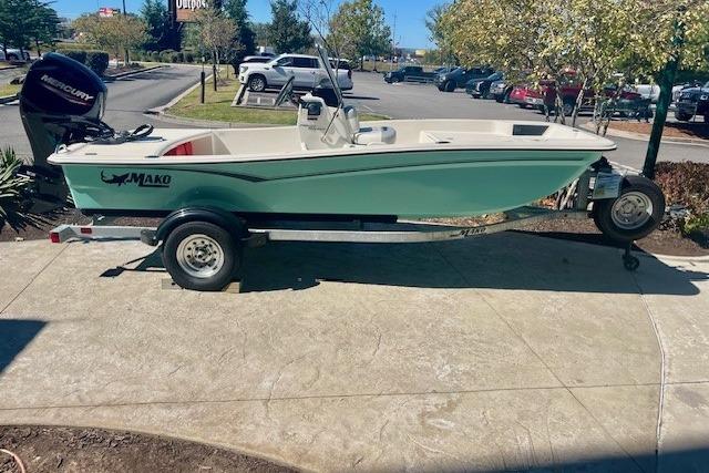 2026 Mako Pro Skiff 15 CC boat on trailer, parked outdoors in a sunny area.